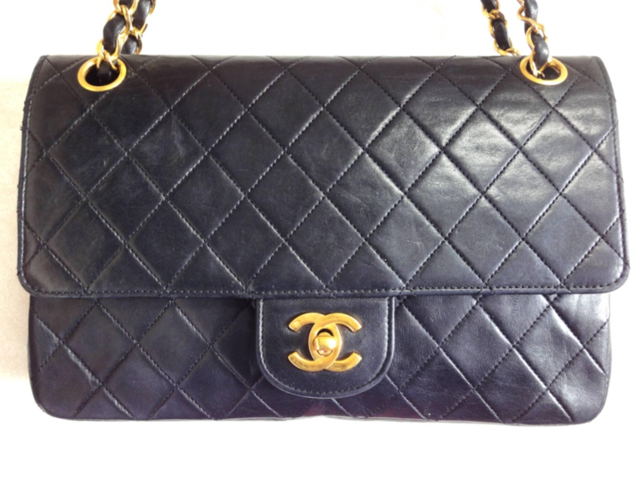 1980's vintage Chanel black 2.55 classic double flap purse with golden CC motif closure and golden chain straps.

Introducing one of the most classic bag from CHANEL back in the 80's, black lambskin classic 2.55 double flap purse.

If you are