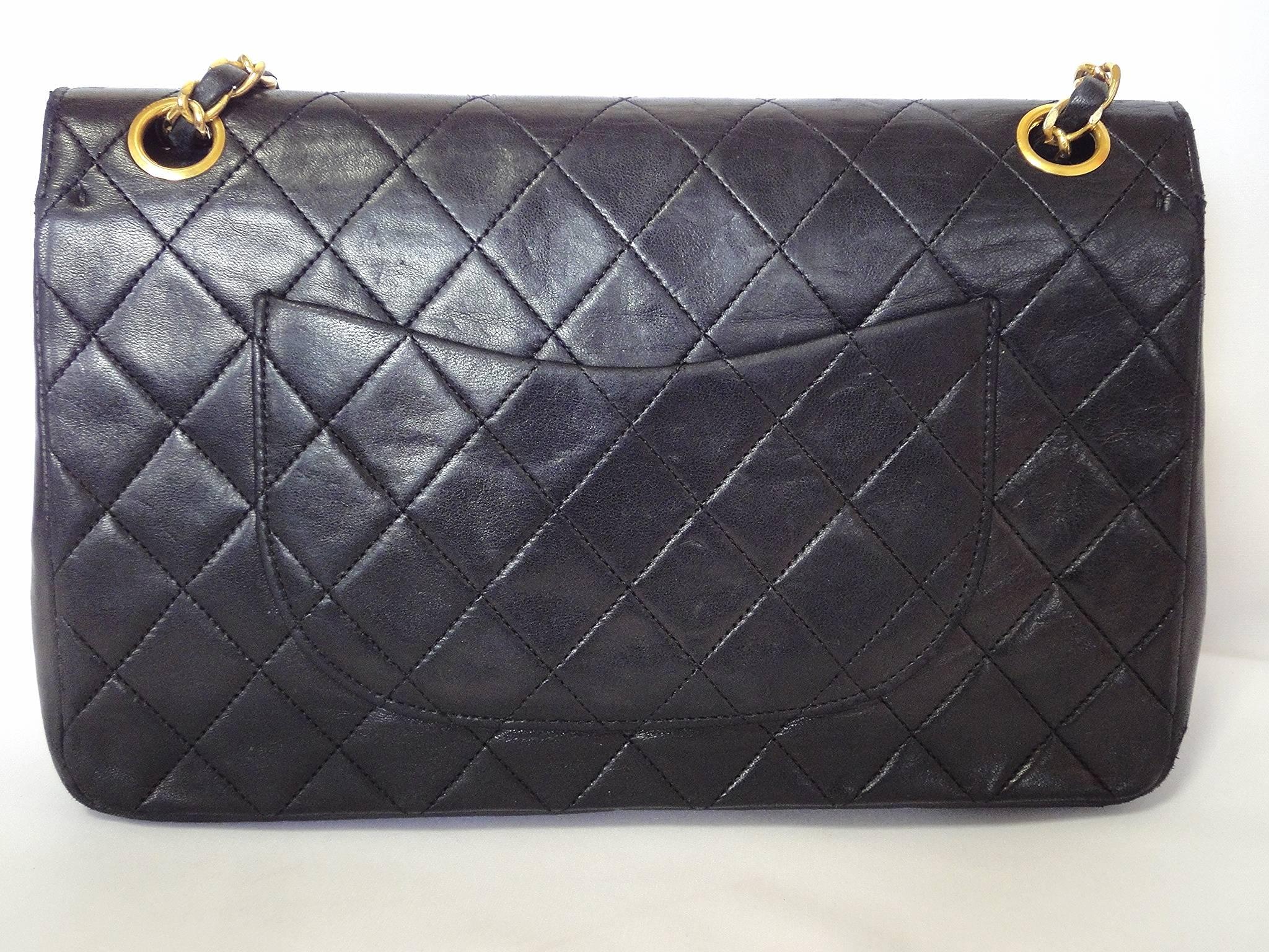 Black 1980's vintage Chanel black 2.55 classic double flap bag with golden chain strap