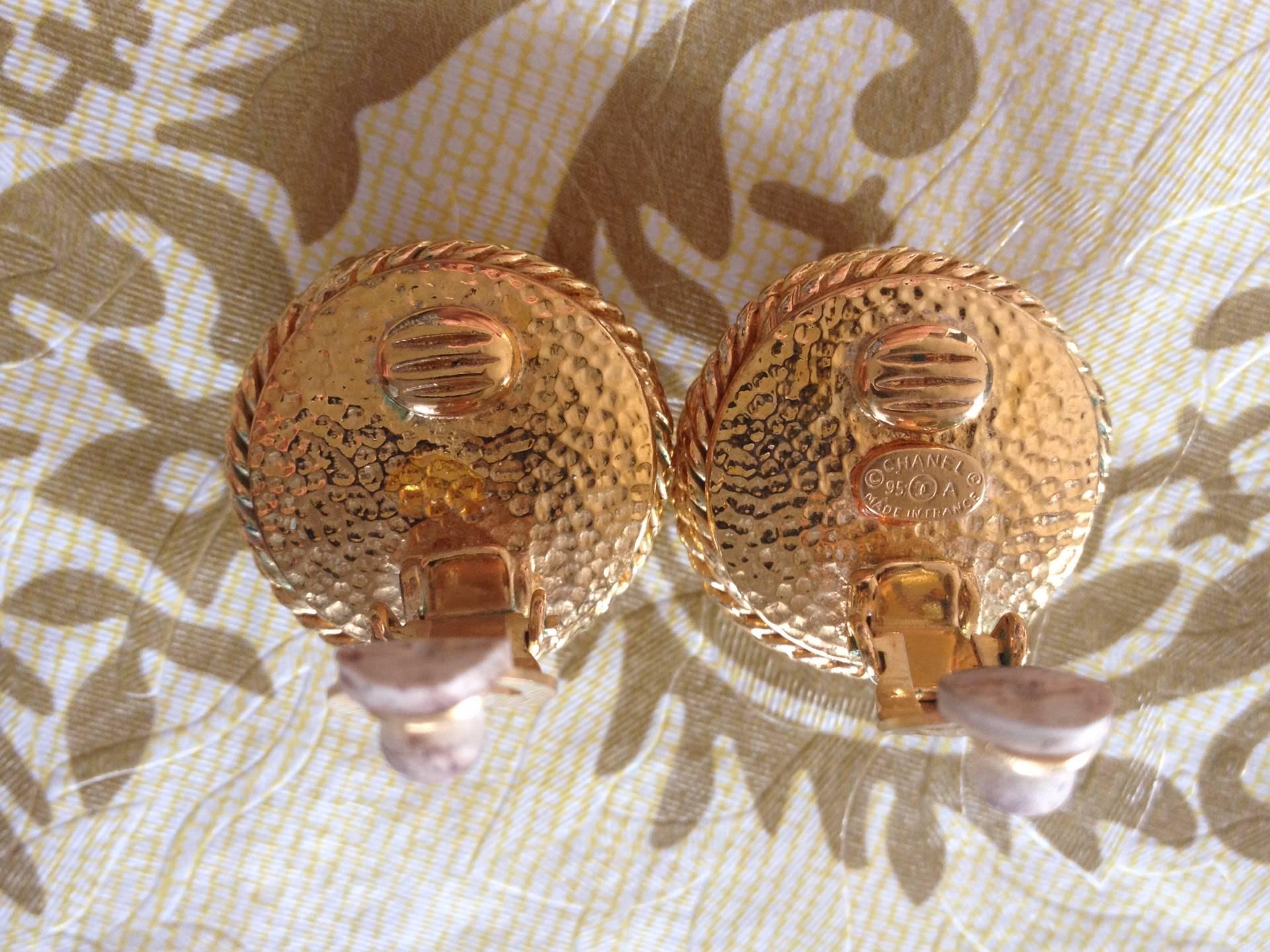 Vintage CHANEL gold tone round earrings with twisted frames, a faux pearl and CC 1
