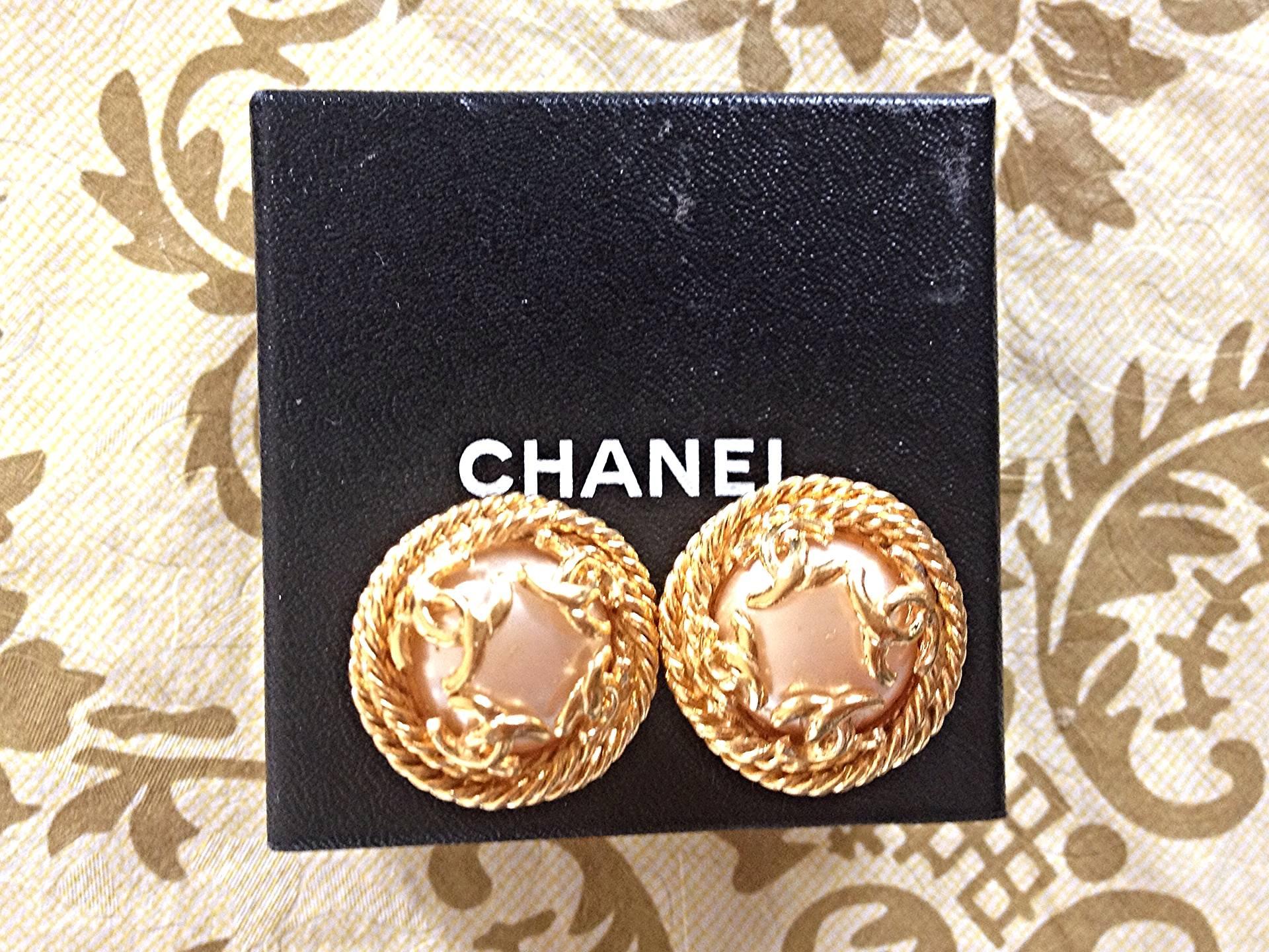 Vintage CHANEL gold tone round earrings with twisted frames, a faux pearl and CC 2