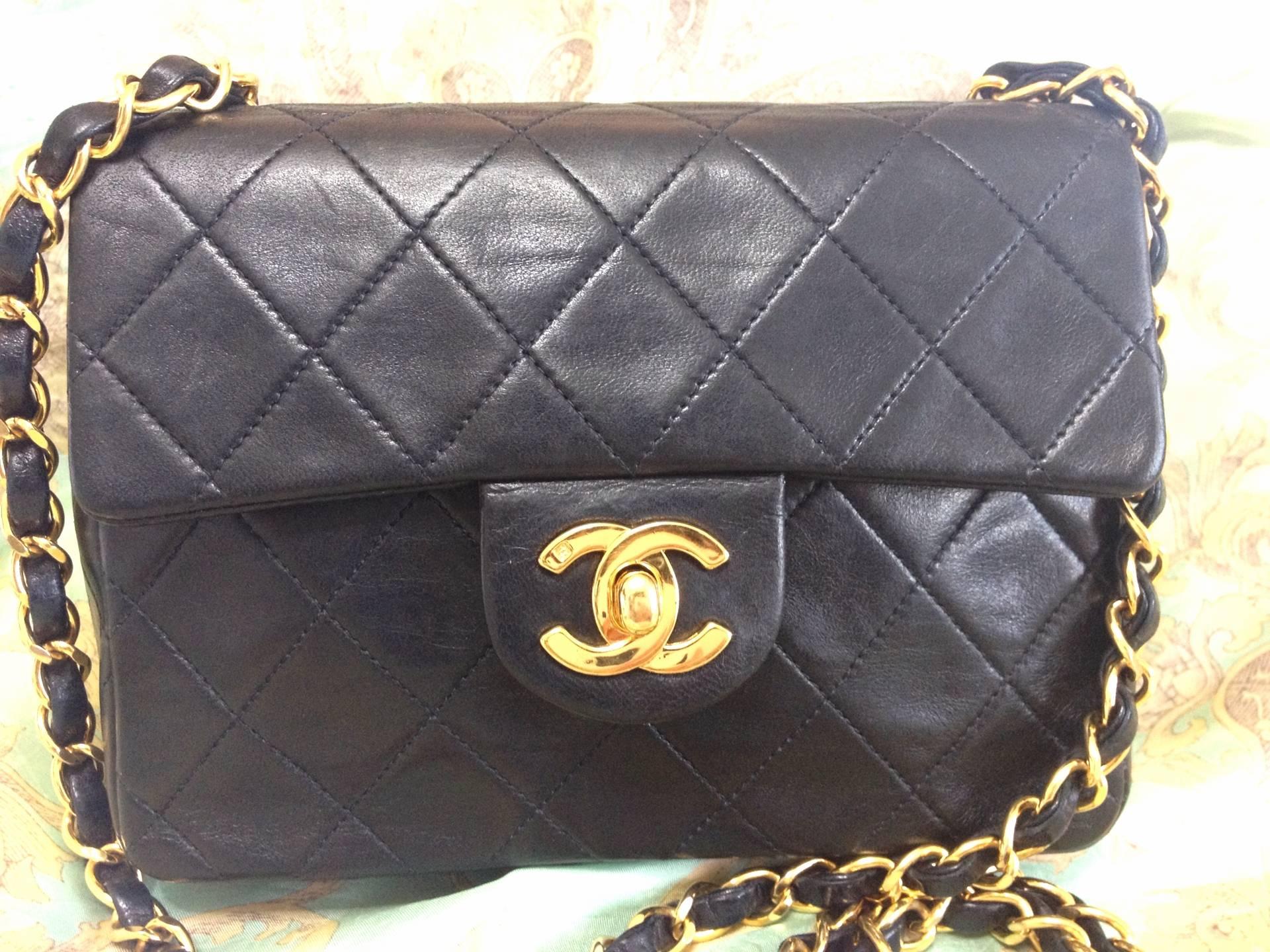 Vintage CHANEL black lamb leather flap chain shoulder bag, classic 2.55 mini purse with gold tone CC closure.

Vintage CHANEL black color lambskin classic 2.55 mini shoulder bag with golden chains and cc closure.

Introducing one of the most
