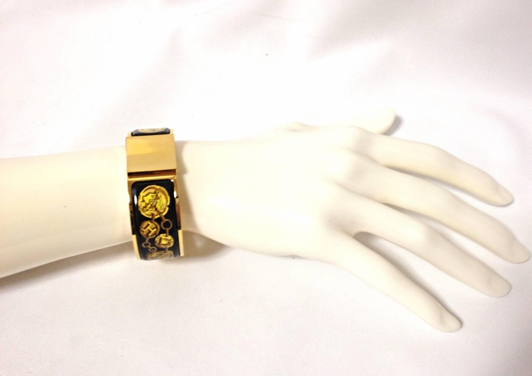 1990s. Vintage Hermes round shape cloisonne enamel golden click and clack Flacon bangle with black, yellow and gold. Great gift idea.

Fabulous bangle in HERMES's iconic cloisonne enamel.
Excellent  beauty and elegance with black, yellow, and