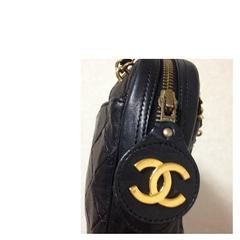 80's vintage CHANEL black lambskin classic bag with golden chains and cc charm.