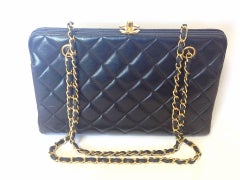 Vintage CHANEL black leather chain shoulder bag with golden CC kiss lock closure