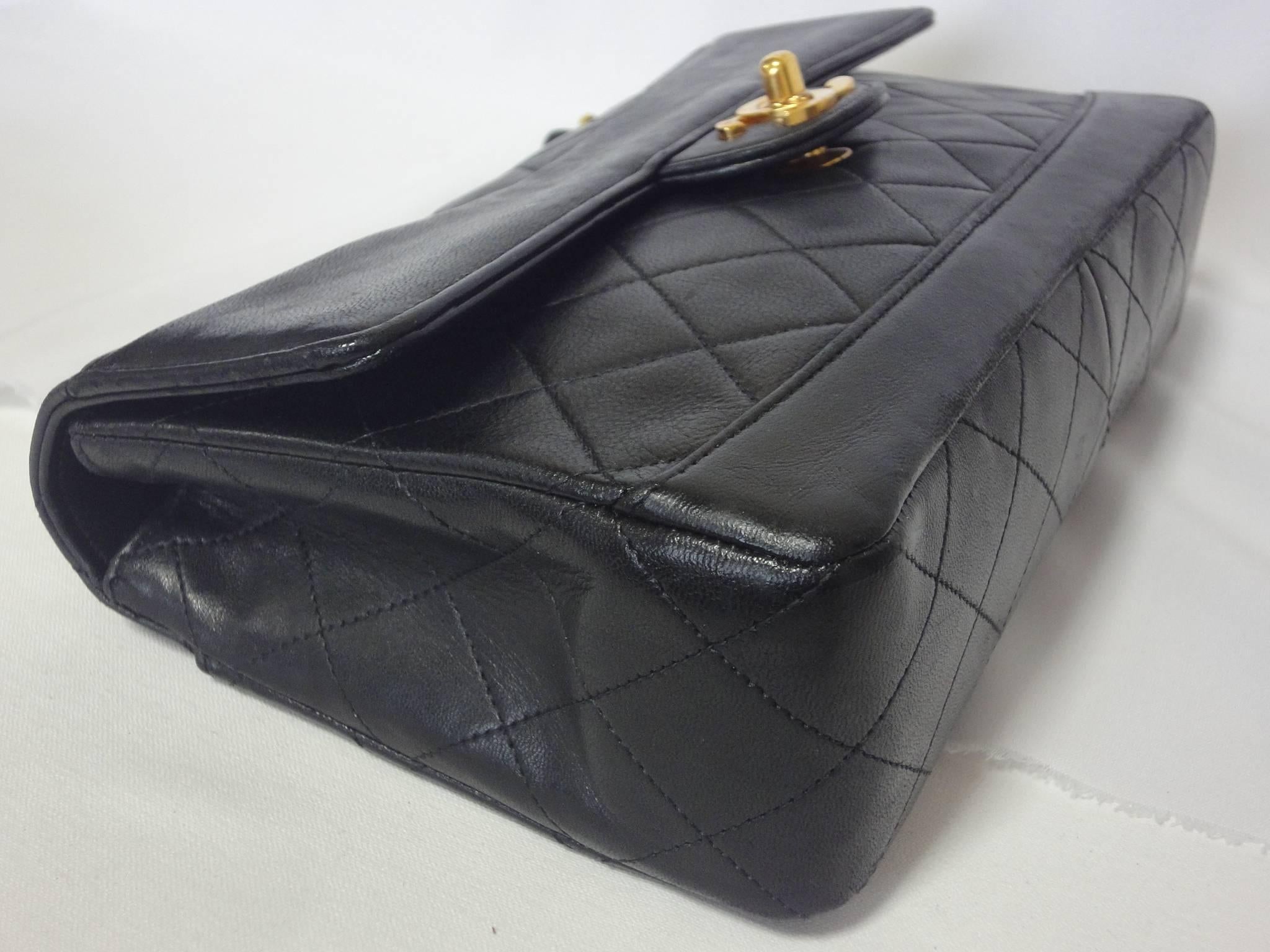 Women's Vintage Chanel classic 2.55 black lambskin shoulder bag with golden chain straps