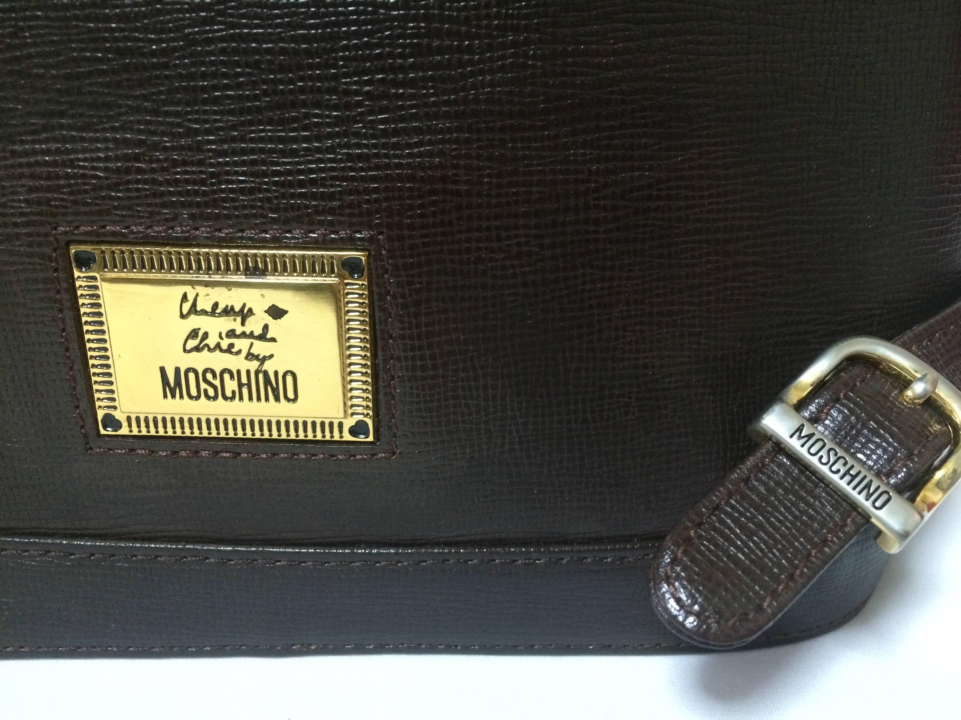 Black Vintage MOSCHINO dark brown leather backpack with golden and black M logo. For Sale