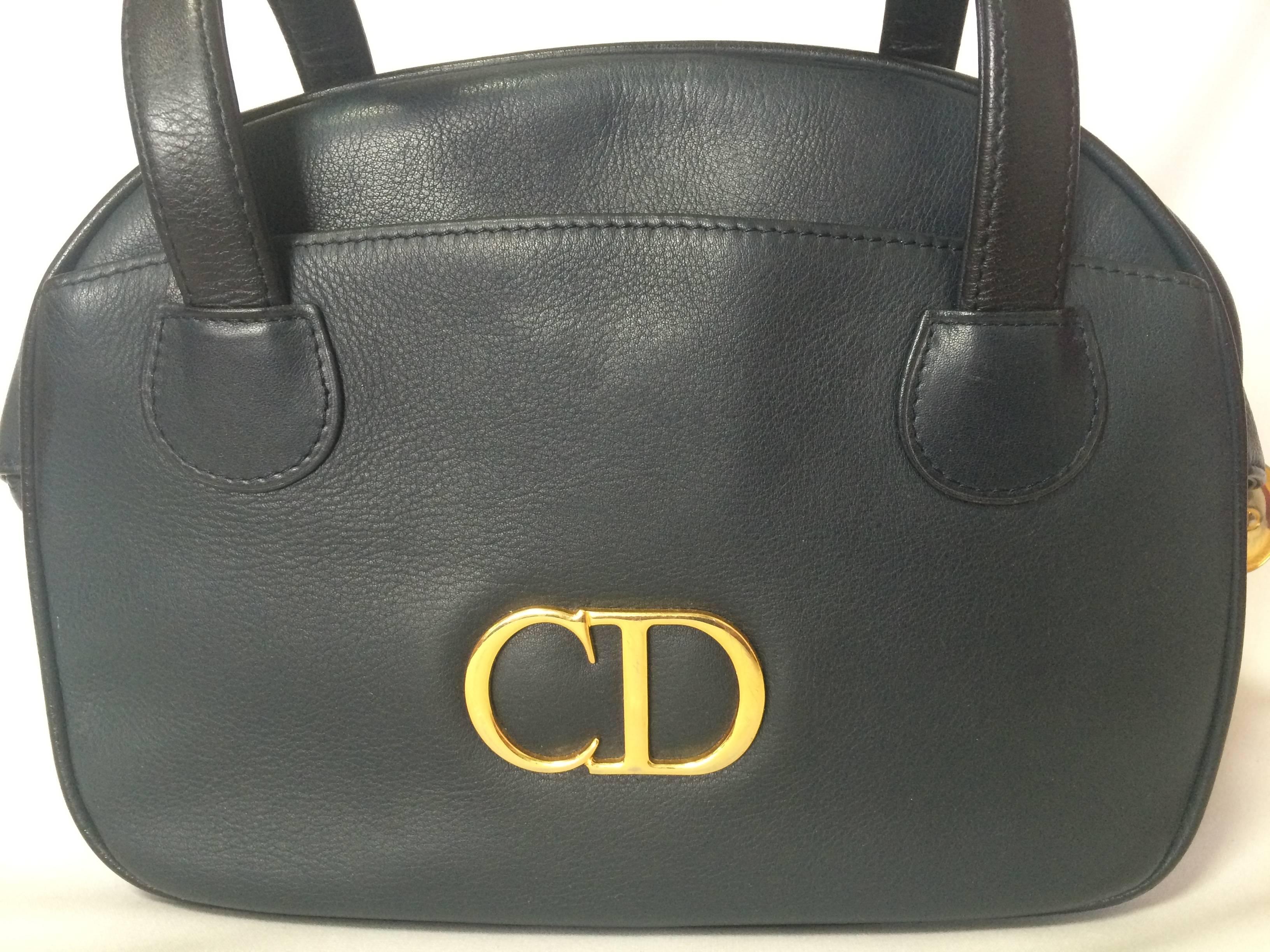 1990s. Vintage Christian Dior navy leather bolide style handbag with golden large CD logo. Classic style but rare design. Daily use.

Introducing another adorable vintage purse from Christian Dior back in the 90s.
If you are looking for a unique