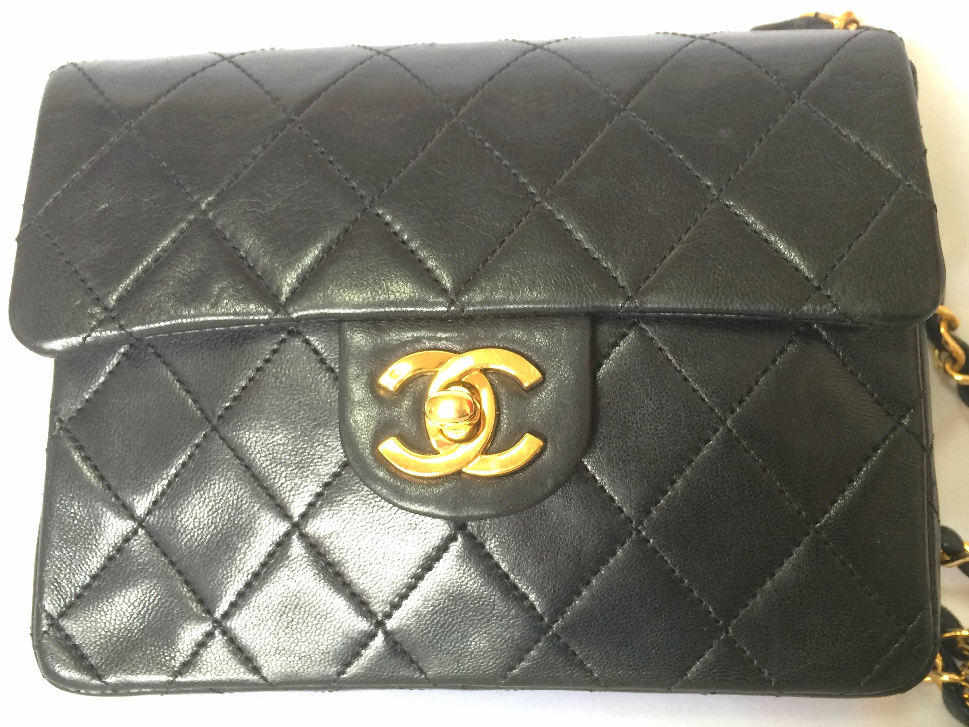 1980's vintage CHANEL black lamb leather flap chain shoulder bag, classic 2.55 mini purse with gold tone CC closure.

Vintage CHANEL black color lambskin classic 2.55 mini shoulder bag with golden chains and cc closure.

Introducing one of the