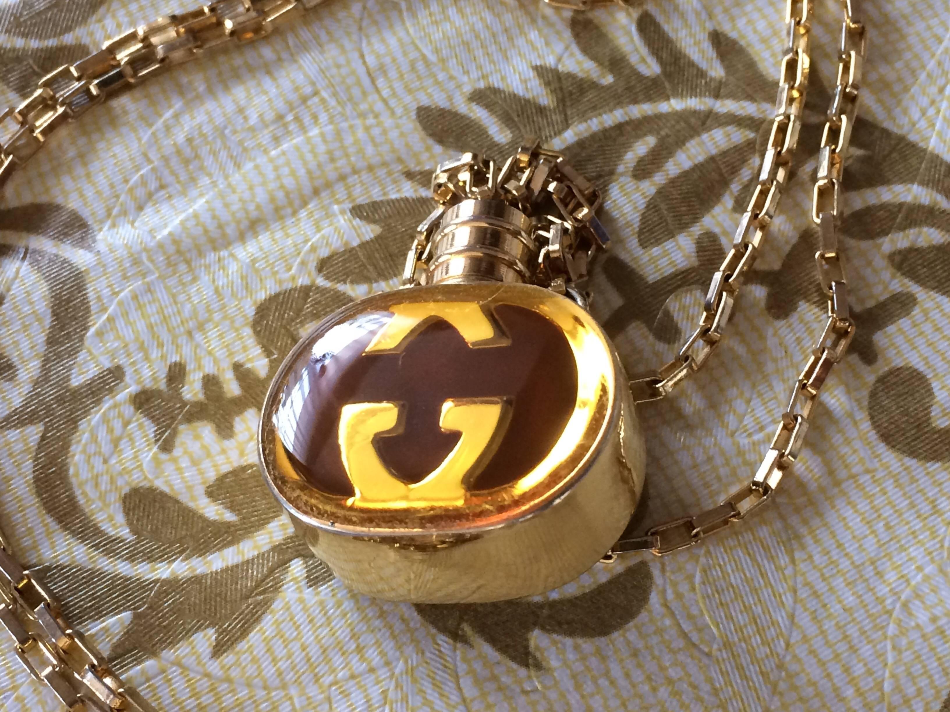 1980s. Vintage Gucci gold and brown round shape perfume bottle necklace with iconic logo mark. Perfect rare Gucci gift.

Beautiful vintage condition!

If you are looking for vintage Gucci necklace, then do not miss this opportunity!
Here is