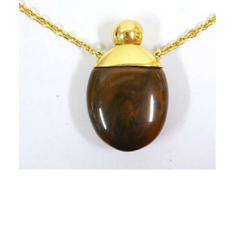 1970s. Vintage Givenchy gold chain necklace with gold tone logo motif and brown marble stone perfume bottle pendant top. Statement necklace.

Another FAB and stunning jewelry necklace from GIVENCHY back in the 70's.

The pendant top features a