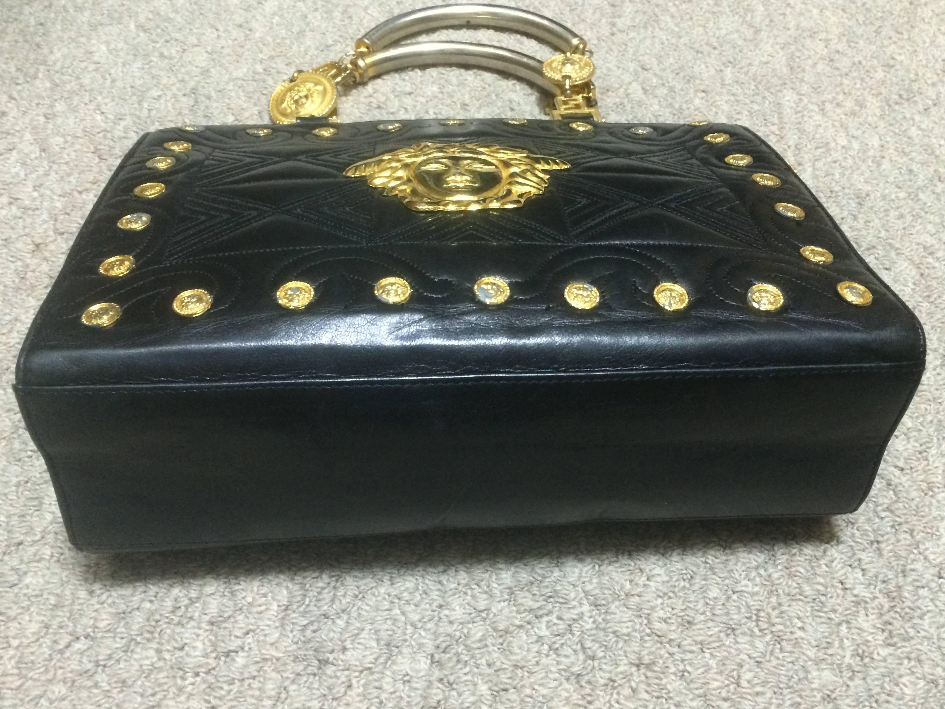 Vintage Gianni Versace black tote bag with golden medusa charms and handles. 2