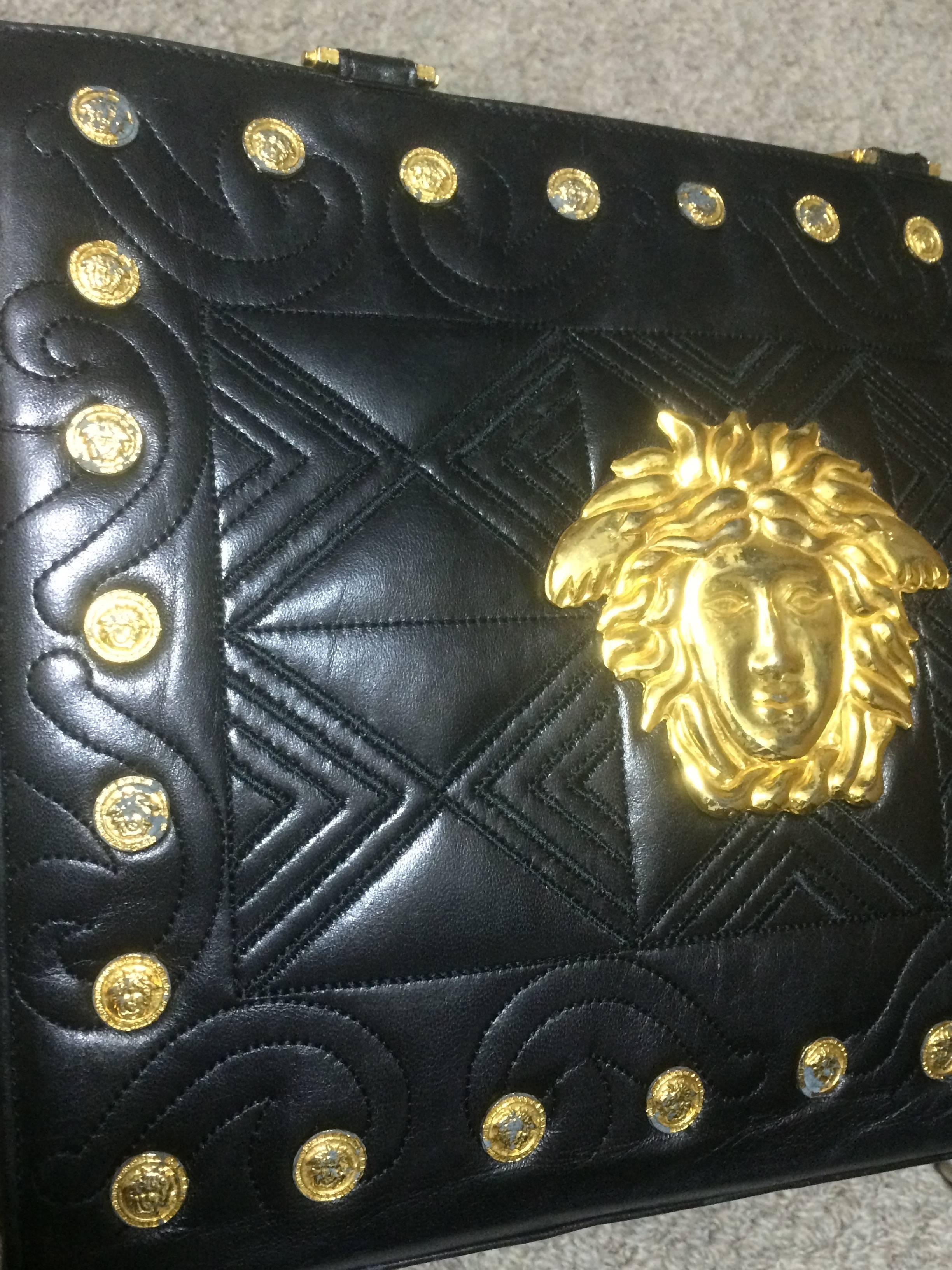 Black Vintage Gianni Versace black tote bag with golden medusa charms and handles.
