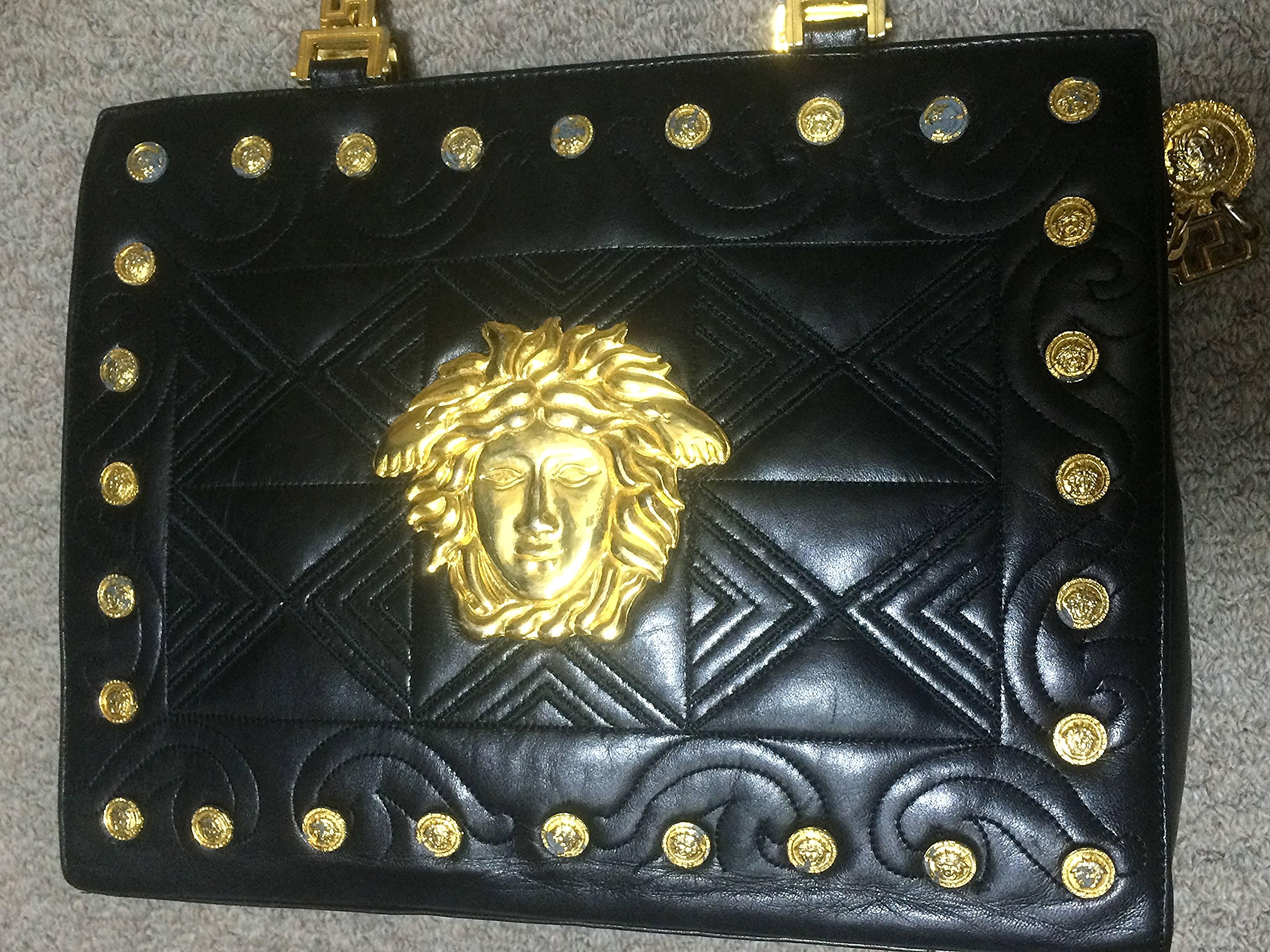 1990s. Vintage Gianni Versace black leather tote bag with big golden medusa charms, and gold tone hardwares. Too Gorgeous like Lady Gaga.

This is one sophisticated and RARE masterpiece from GIANNI VERSACE in the old era. 
If you are looking for