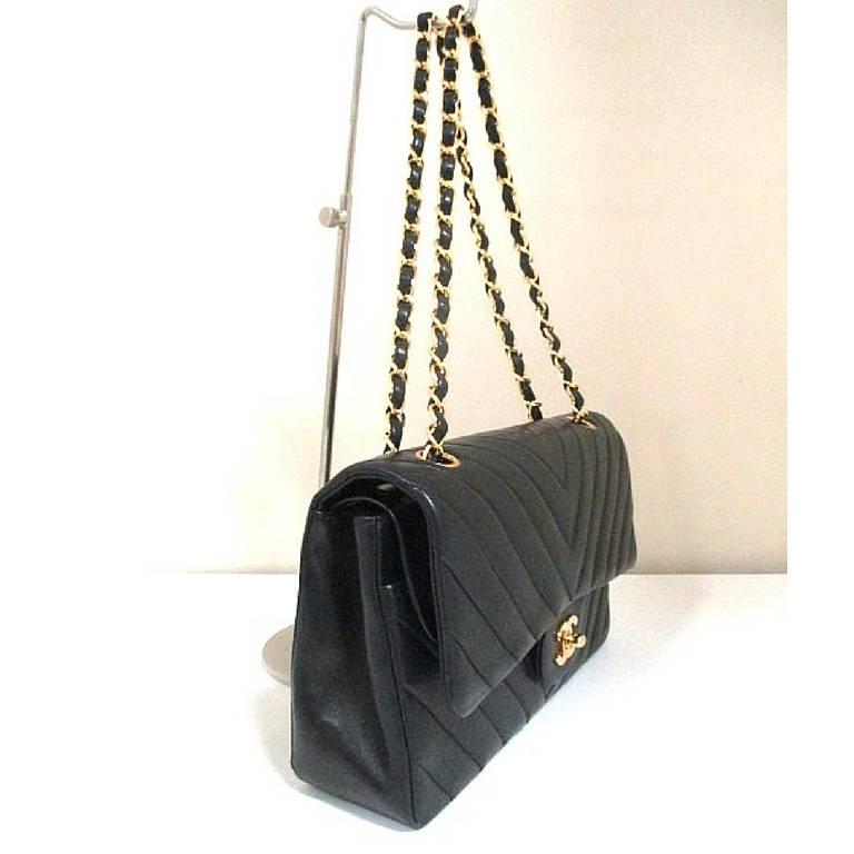 Black Vintage CHANEL classic double flap 2.55 chain shoulder bag with chevron stitch. 
