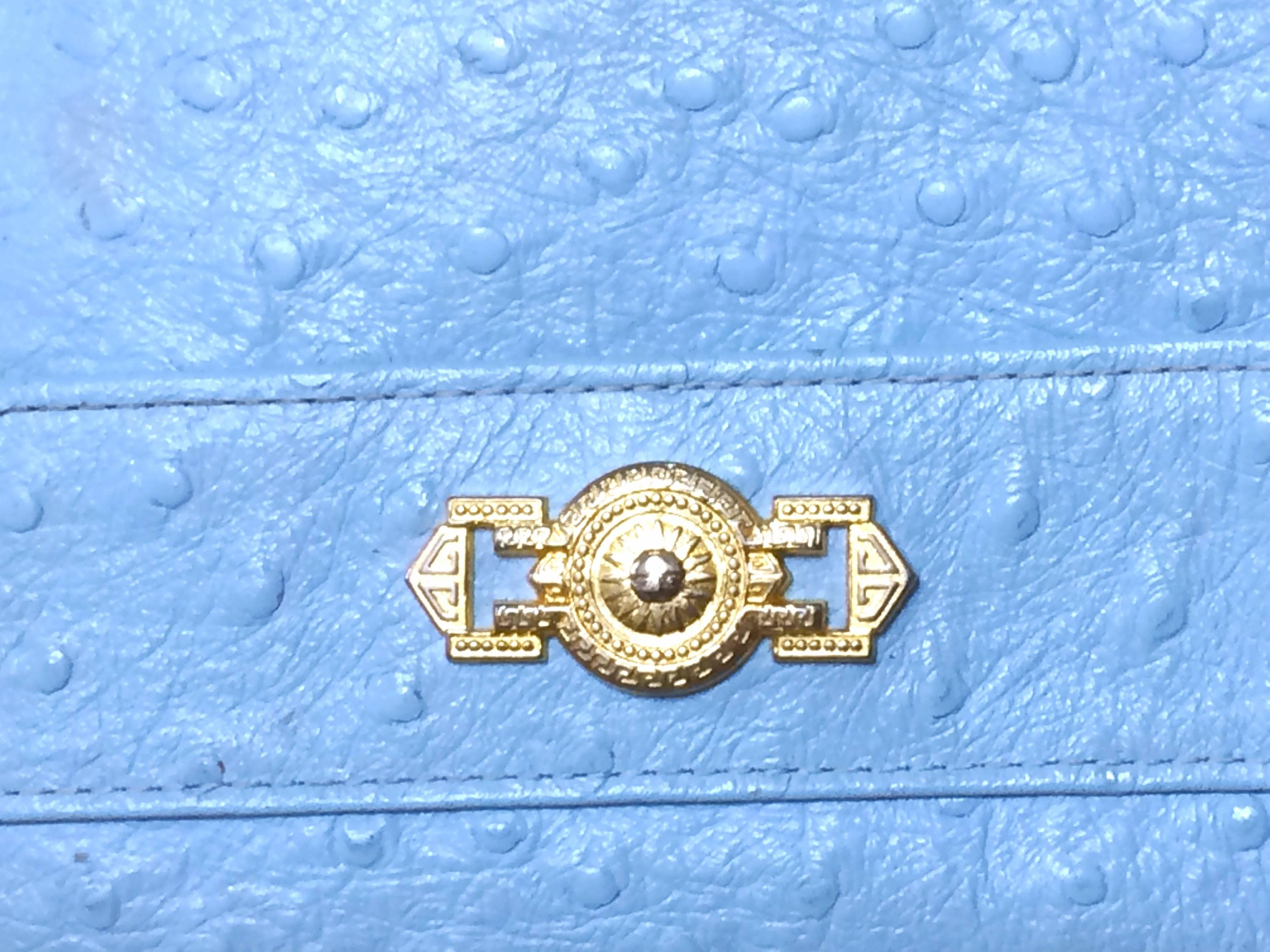 1990s. Vintage Gianni Versace ostrich-embossed light blue leather wallet with golden sunburst charm. Coin purse, card,bill case. Best gift 

Here is another vintage piece from Gianni Versace, ostrich-embossed light blue leather wallet that can