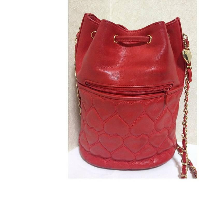 1990s. Vintage MOSCHINO red heart shape quilted lambskin shoulder hobo bucket purse with chain straps. Too cute to carry.

Introducing a chic and cute vintage piece from Moschino back in the early 90's!
You will love the red heart shape quiltings
