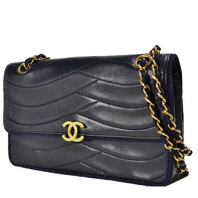 1980's rare vintage Chanel navy 2.55 bag in fish scale stitch with matching rope string and golden chain strap. Very rare piece from the era.

Introducing another very rare vintage CHANEL navy lambskin 2.55 purse in fish scale design stitch with