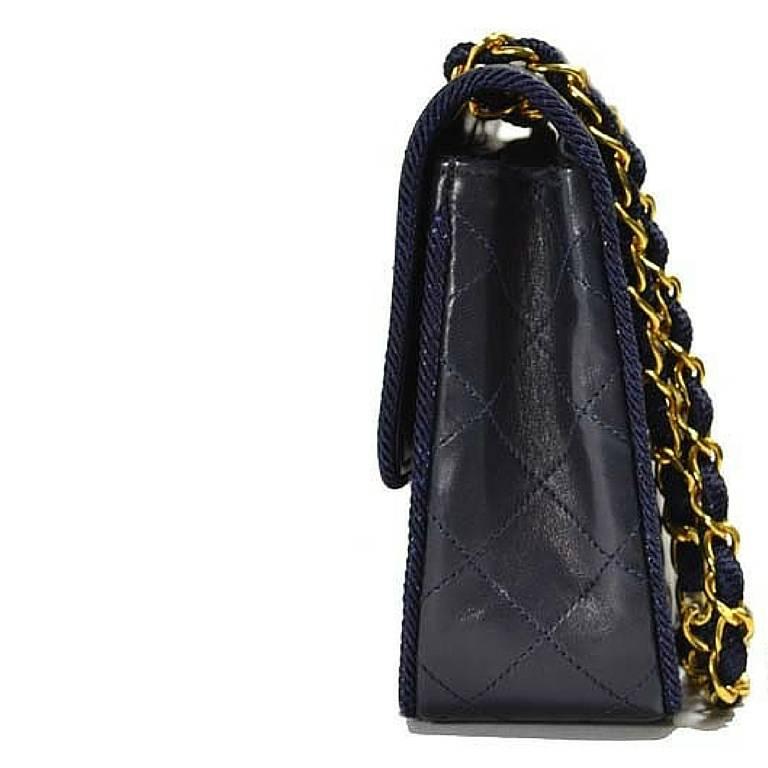 Black Vintage Chanel navy 2.55 bag in fish scale stitch with matching rope and chains.