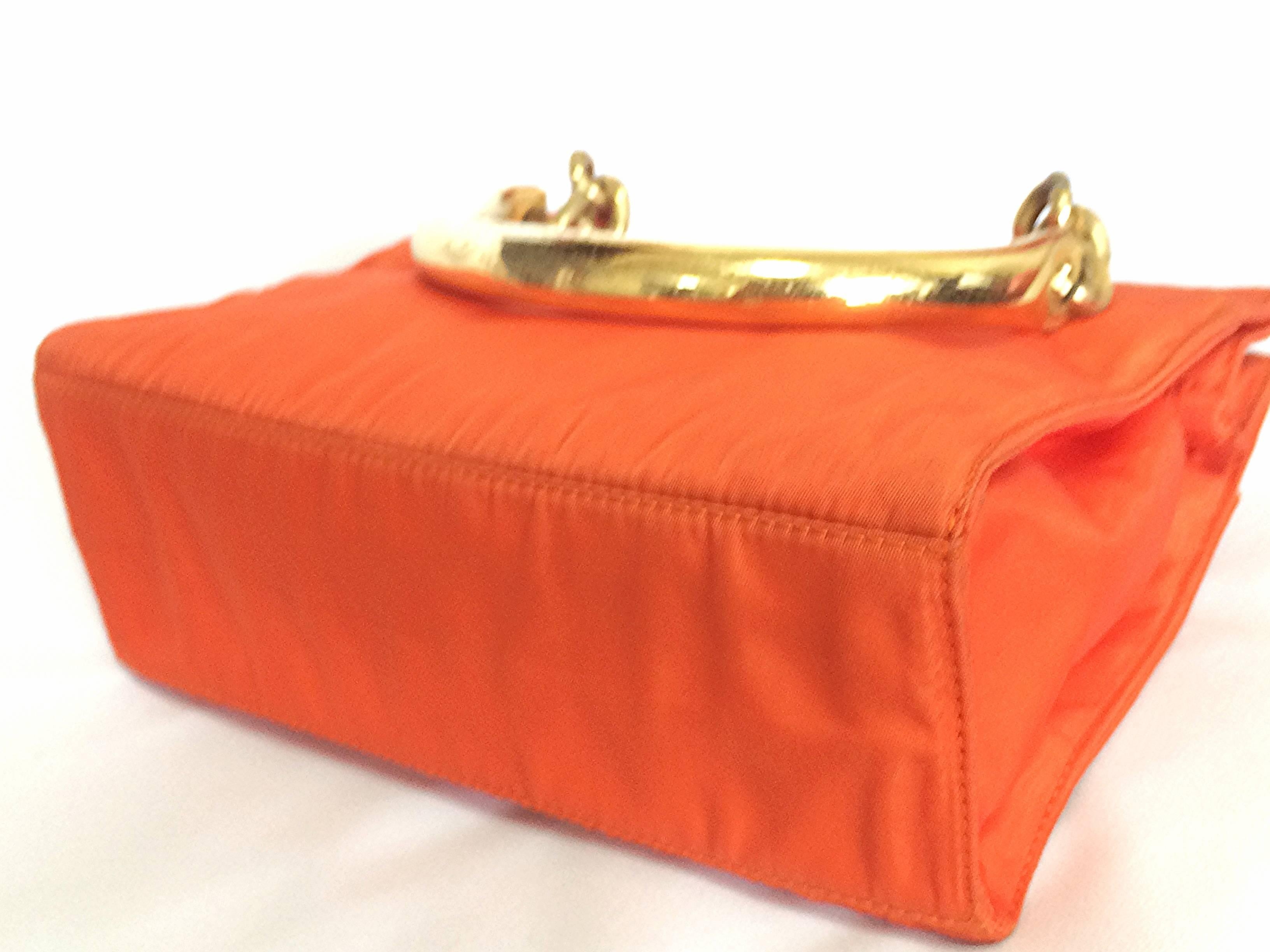 Red Vintage PRADA orange nylon mini tote bag with golden chain and metallic handles.