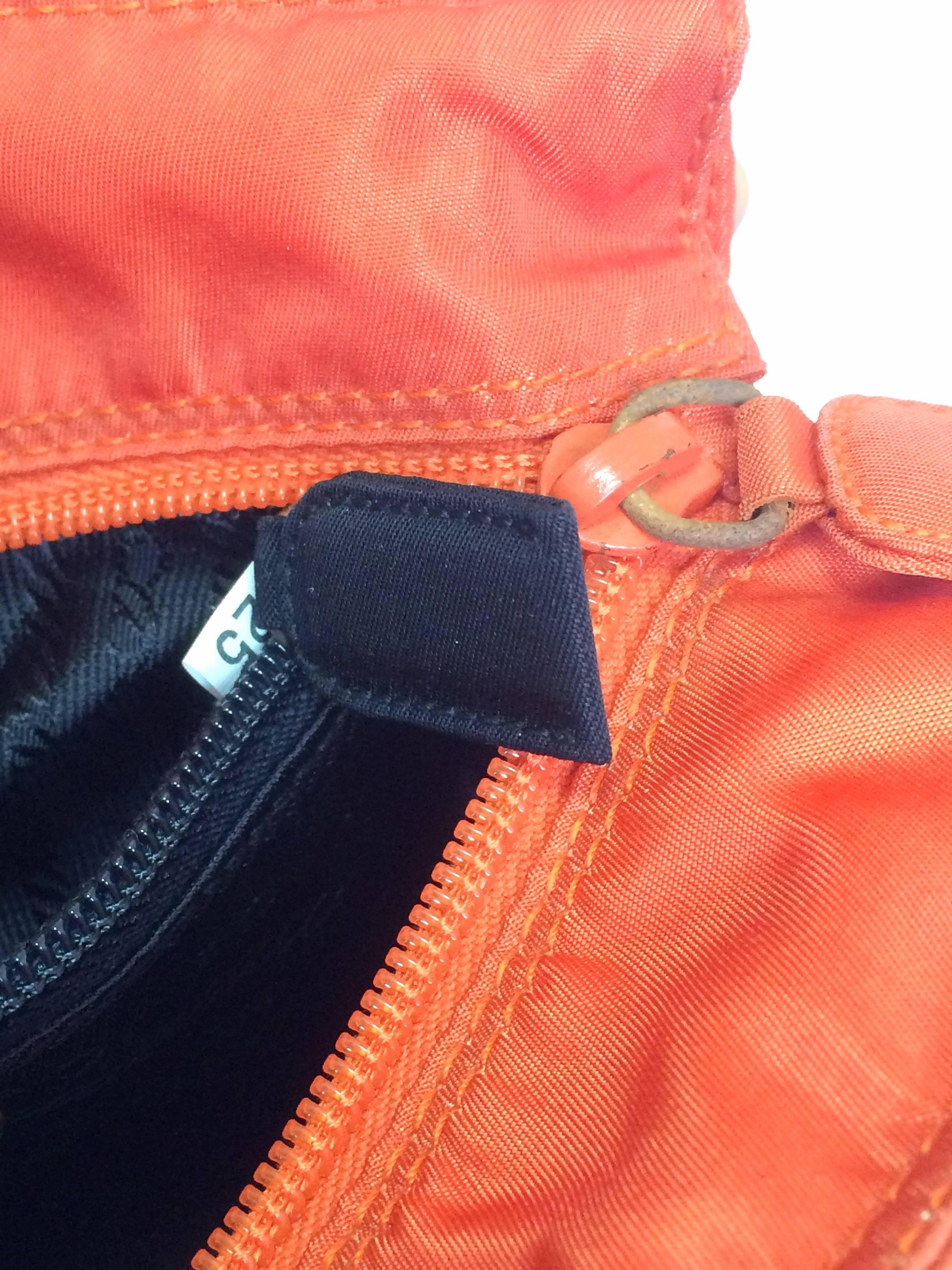 Women's Vintage PRADA orange nylon mini tote bag with golden chain and metallic handles.