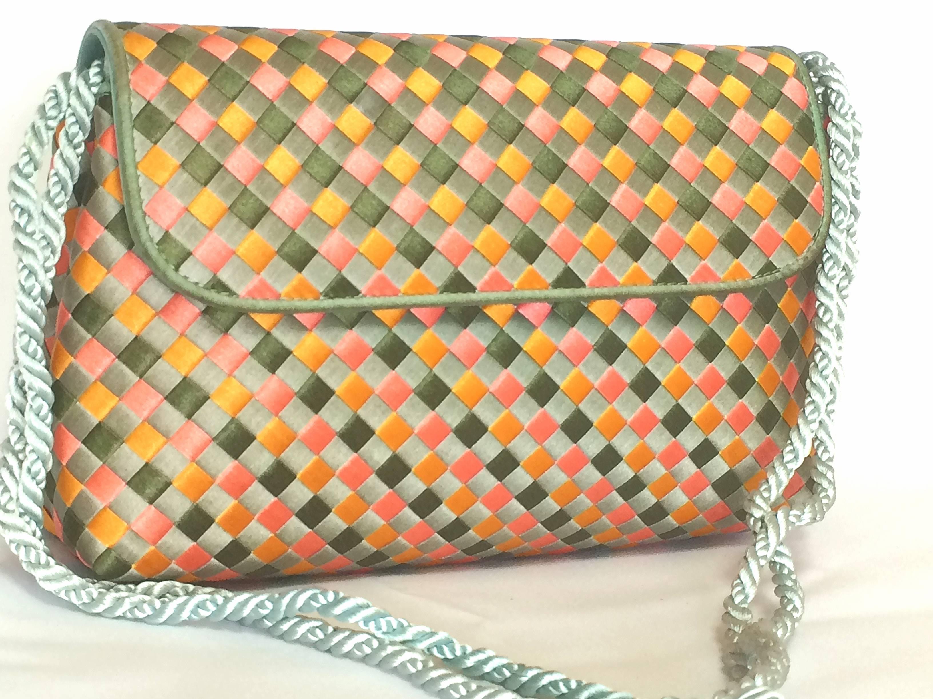 1990s. Vintage Bottega Veneta woven satin, classic intrecciato handbag purse in pink, orange, light blue, and green color. Can be clutch pouch.

Introducing a rare classic masterpiece from Bottega Veneta's iconic intrecciato purse from approx 