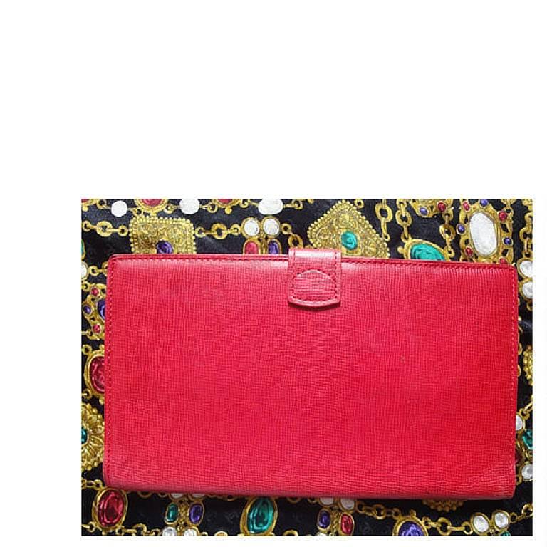 1990s. Vintage Christian Dior red genuine leather wallet with gold tone CD charm.

This is a vintage Christian Dior red leather wallet in a beautiful color of red with golden CD charm on front top.
Very classic and elegant.
Great gift idea as