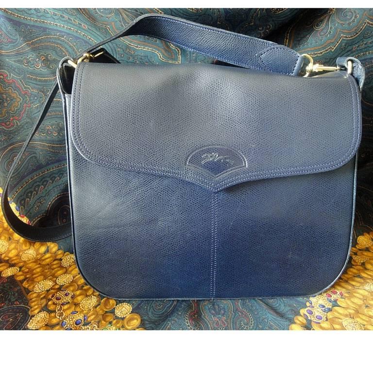 Women's or Men's Vintage Longchamp navy leather shoulder bag with the embossed logo at front flap