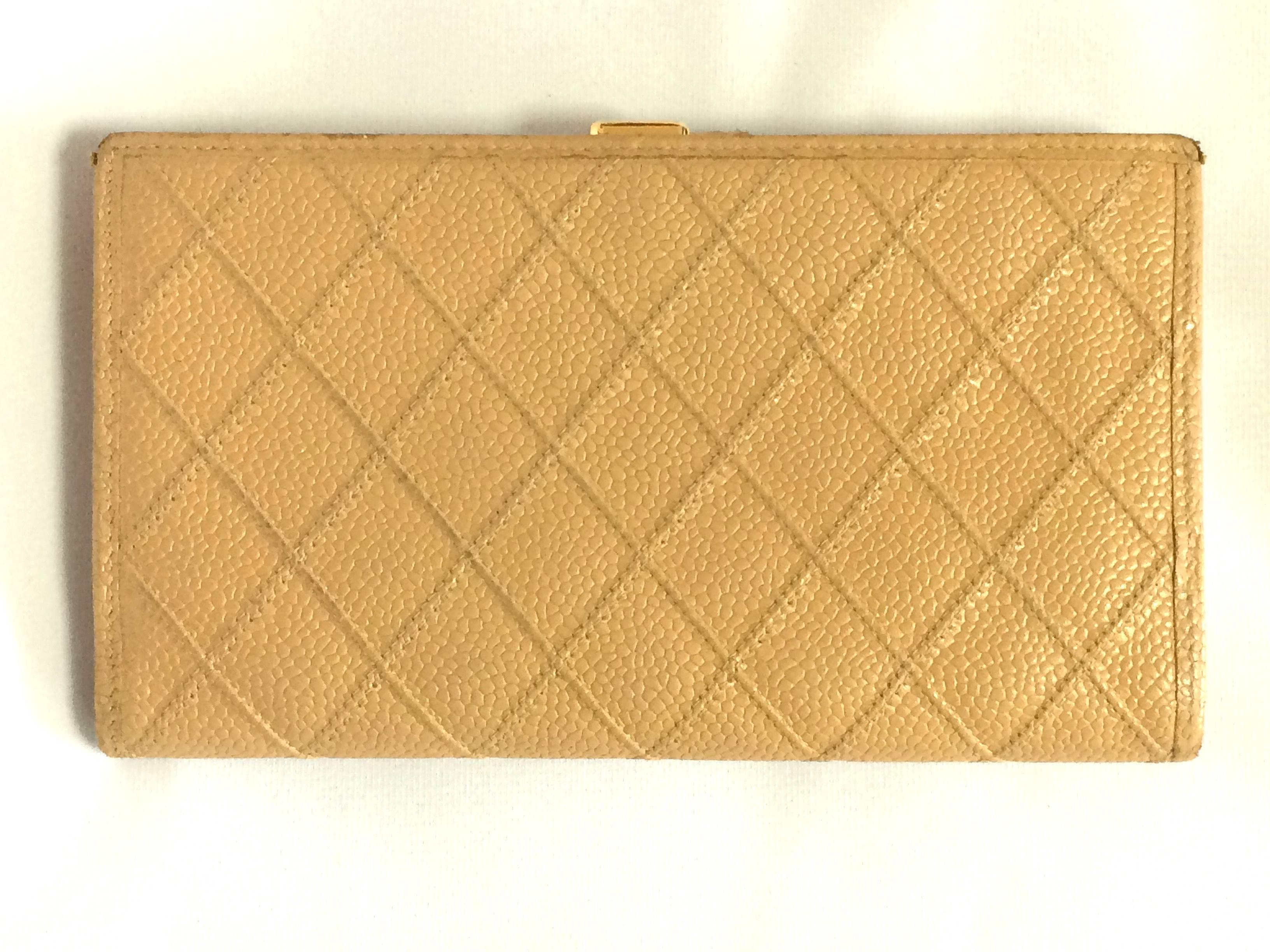 1990s. Vintage CHANEL beige caviar leather wallet with gold tone CC motif. Classic color.

This is a CHANEL vintage wallet in classic beige color caviar skin from the 90's. 
Very sophisticated looking and something that would never go out of