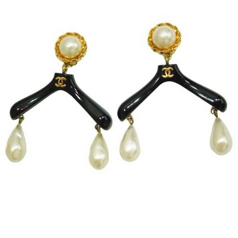 1990s. Vintage CHANEL black hanger design dangle earrings with teardrop faux pearls and golden CC marks.

Introducing one-of-a-kind vintage CHANEL earrings, faux teardrop pearl earrings in black hanger design with golden CC marks on top. 
Normal