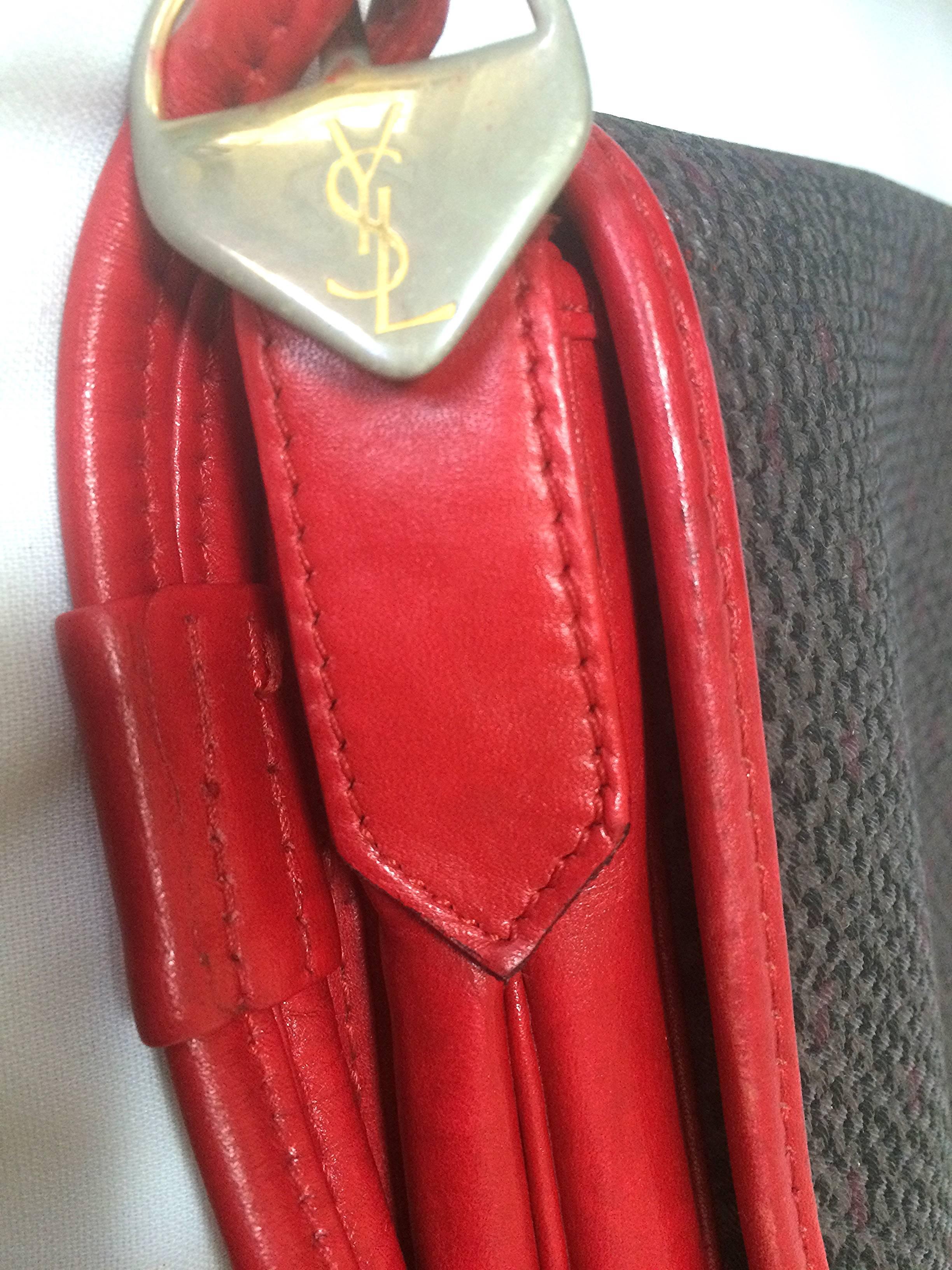 Brown Vintage Yves Saint Laurent oval navy shoulder bag with red shoulder straps. For Sale