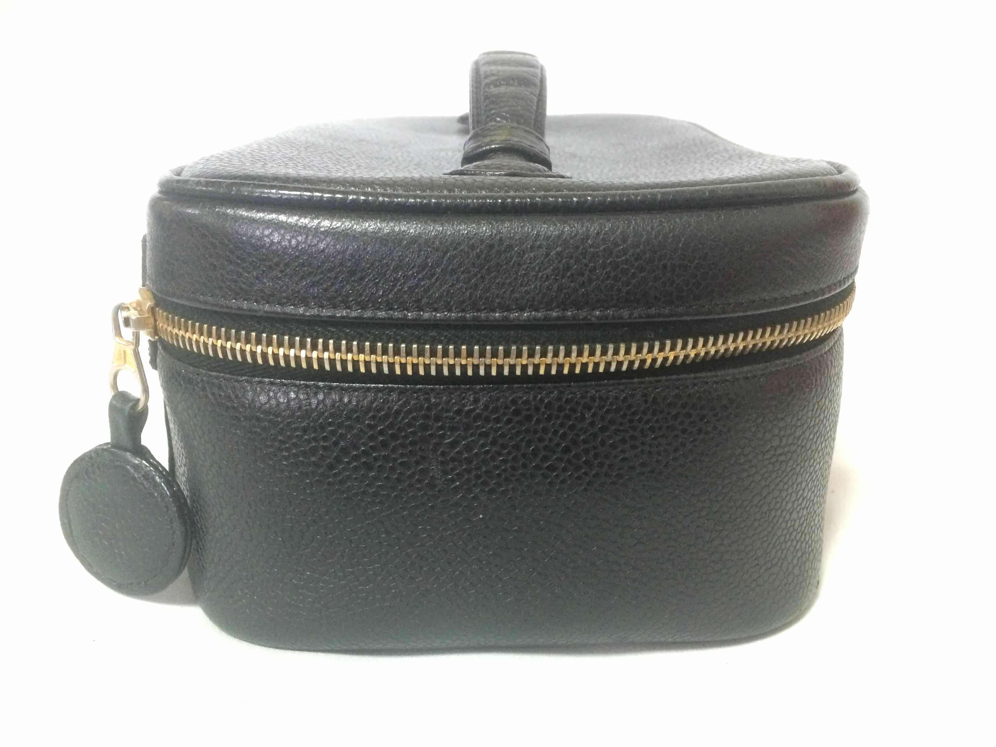 Women's Vintage CHANEL caviarskin cosmetic and toiletry black purse. Classic vanity bag.