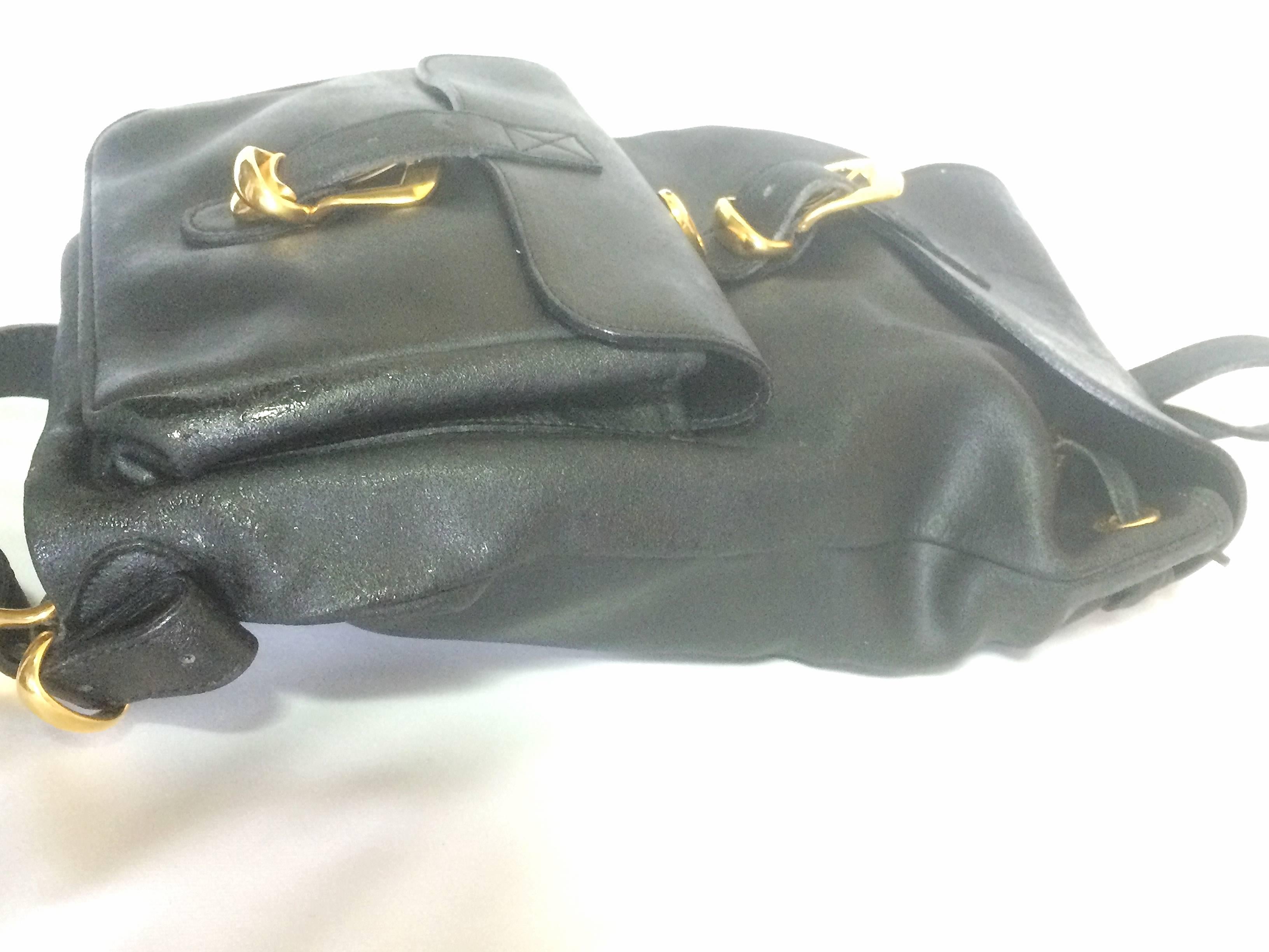 Black Vintage Gianni Versace black leather backpack with a big embossed medusa mark.