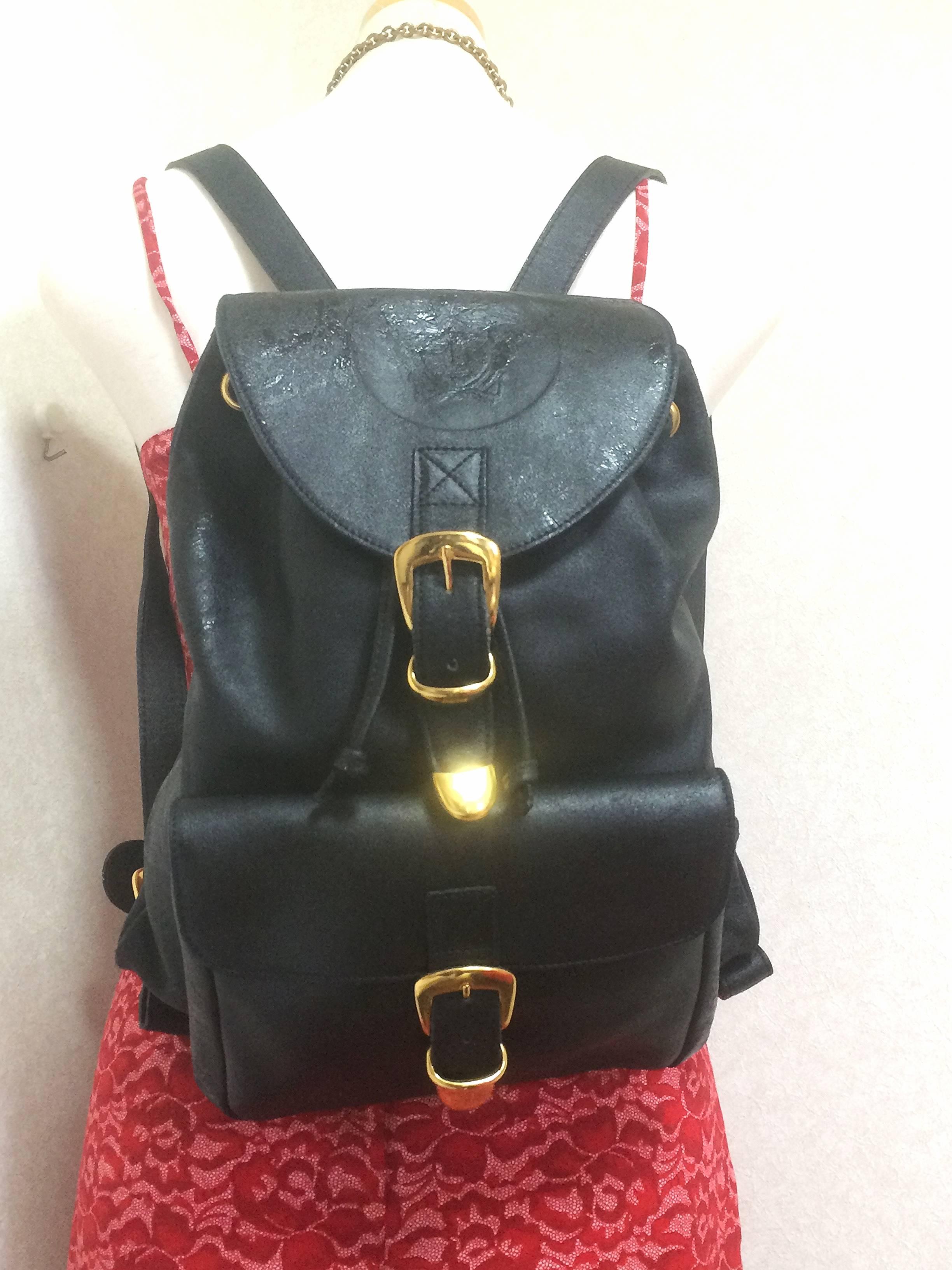 Vintage Gianni Versace black leather backpack with a big embossed medusa mark. 2