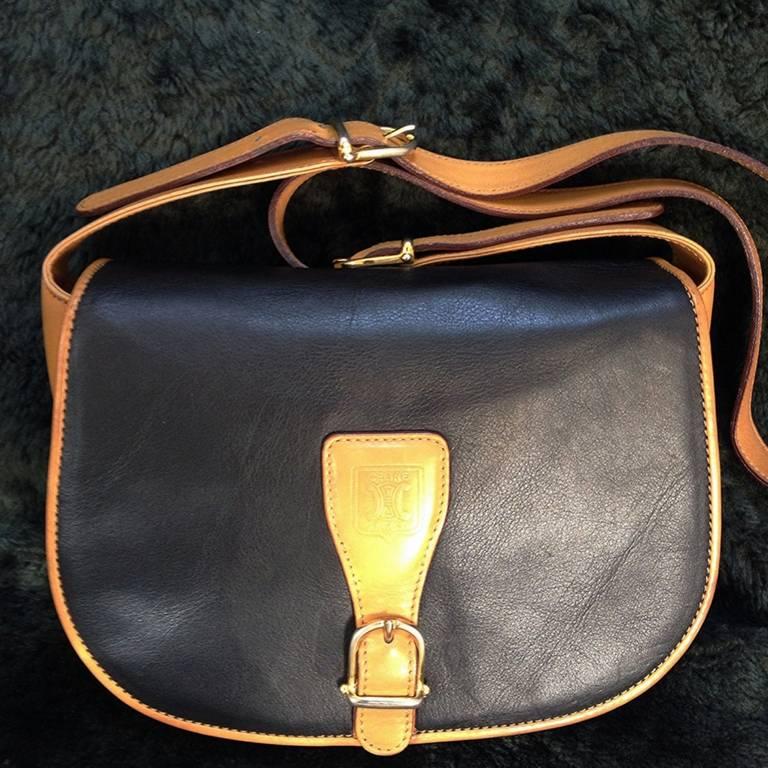 1980s. Vintage Celine black and brown genuine leather shoulder bag with an embossed logo and gold tone hardware. riri zipper.

Introducing a rare vintage Celine shoulder bag in genuine leather back in the 80's. 
You will love the classic black and