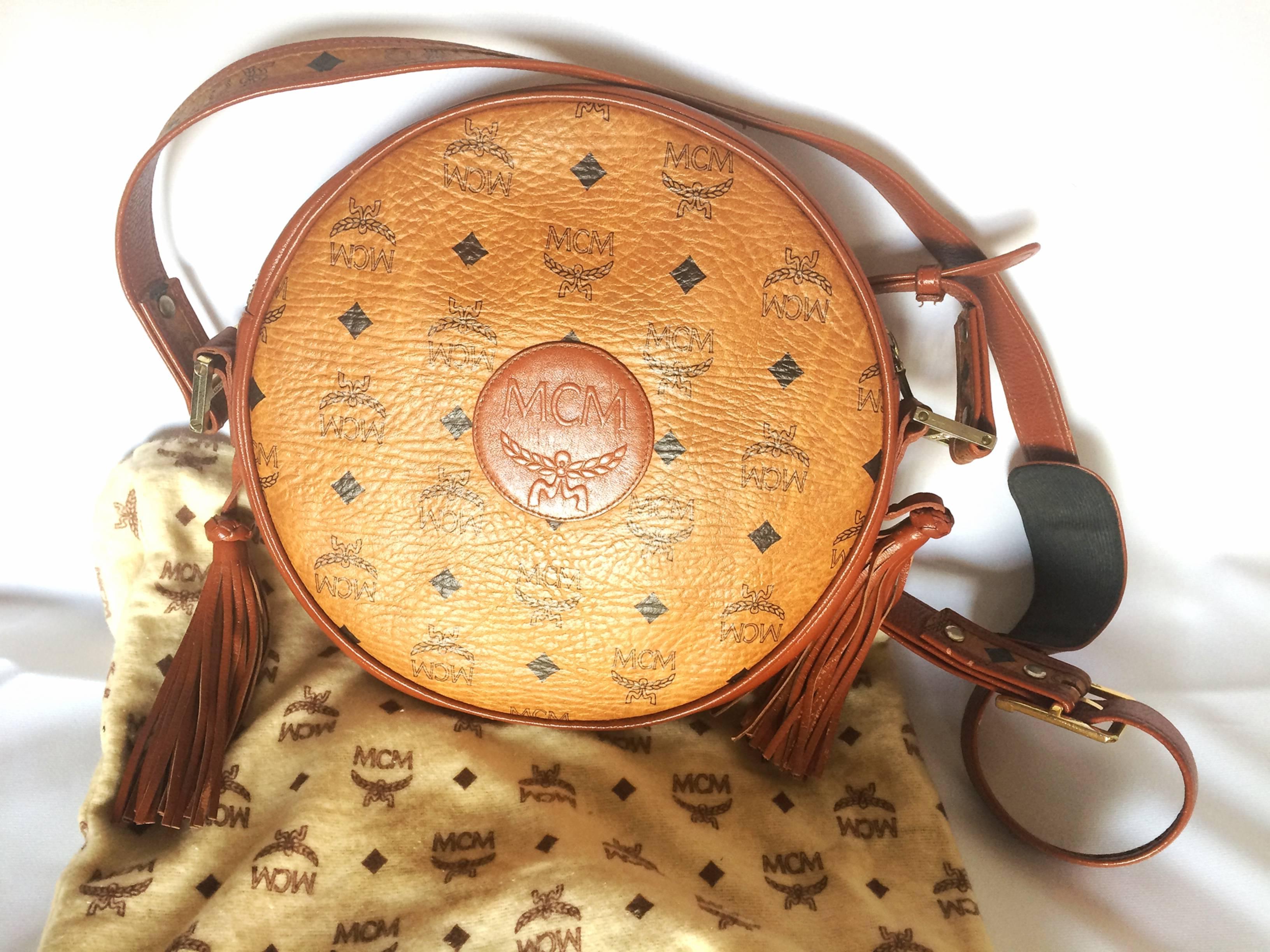 Vintage MCM rare brown monogram round shoulder bag with brown leather trimmings. For Sale 1
