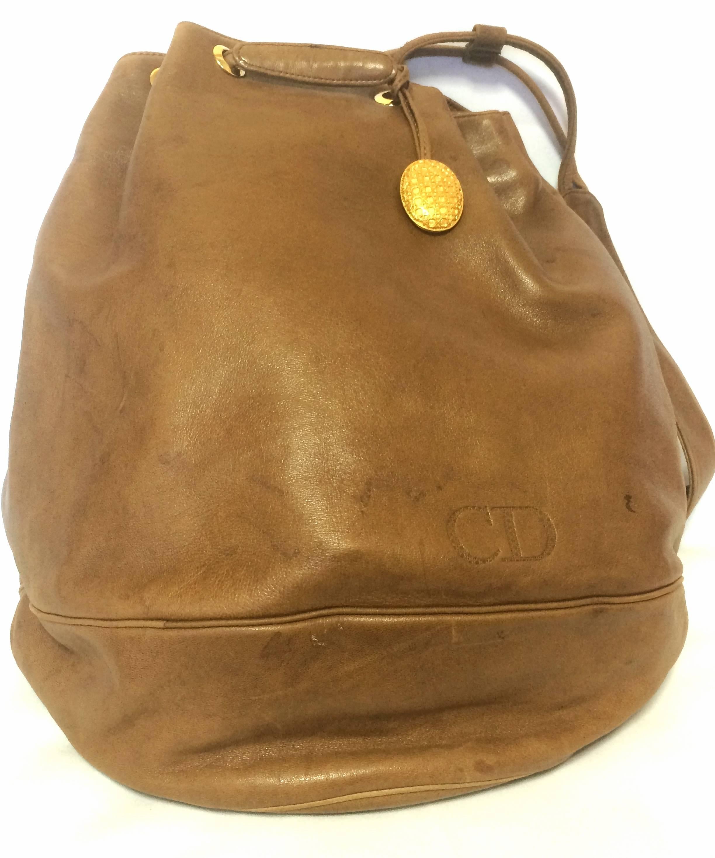 1990s. Vintage Christian Dior brown genuine nappa leather backpack design, large hobo bucket shoulder bag with golden logo. Unisex

Introducing another unique and rare vintage piece from Christian Dior back in the early 90s.

This is like a