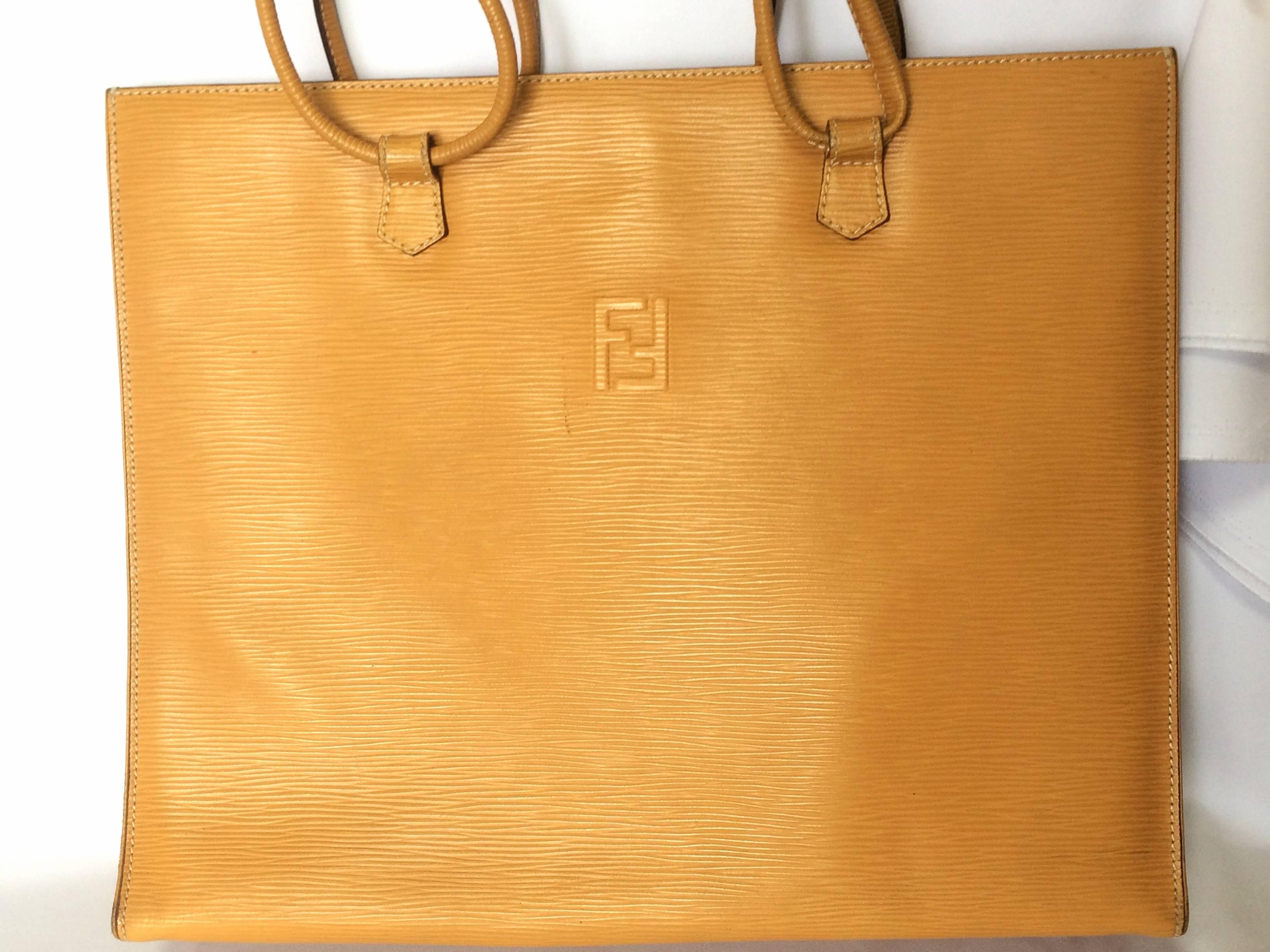 1990s. Vintage FENDI light mustard yellow epi leather extra large shoppers tote bag with logo stitch mark. Rare.

If you are a FENDI vintage collector and lover, then this one will be your must-have piece.

This is a vintage one-of-a-kind piece