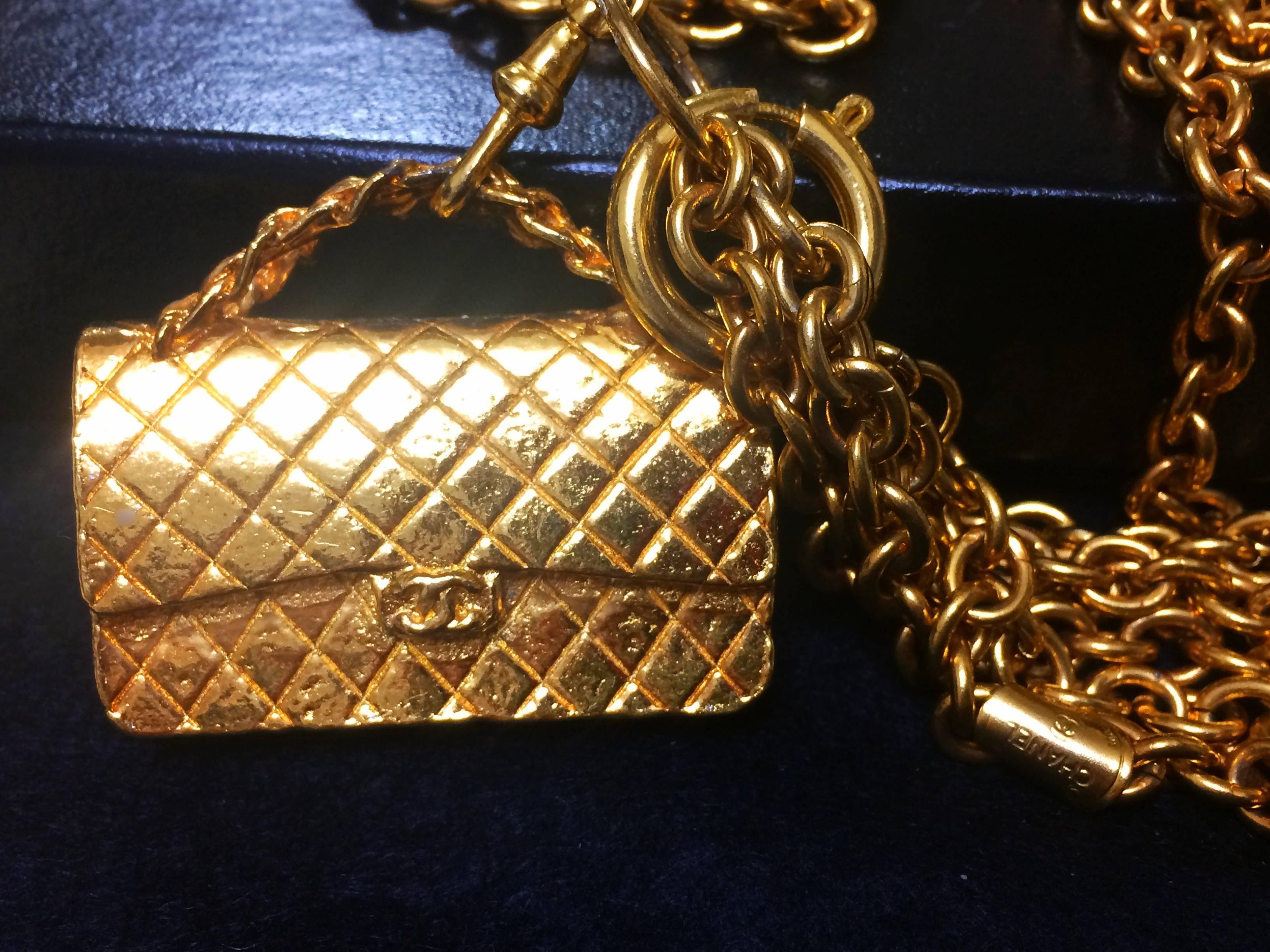 Women's Vintage CHANEL golden double chain long necklace with classic 2.55 bag charm.