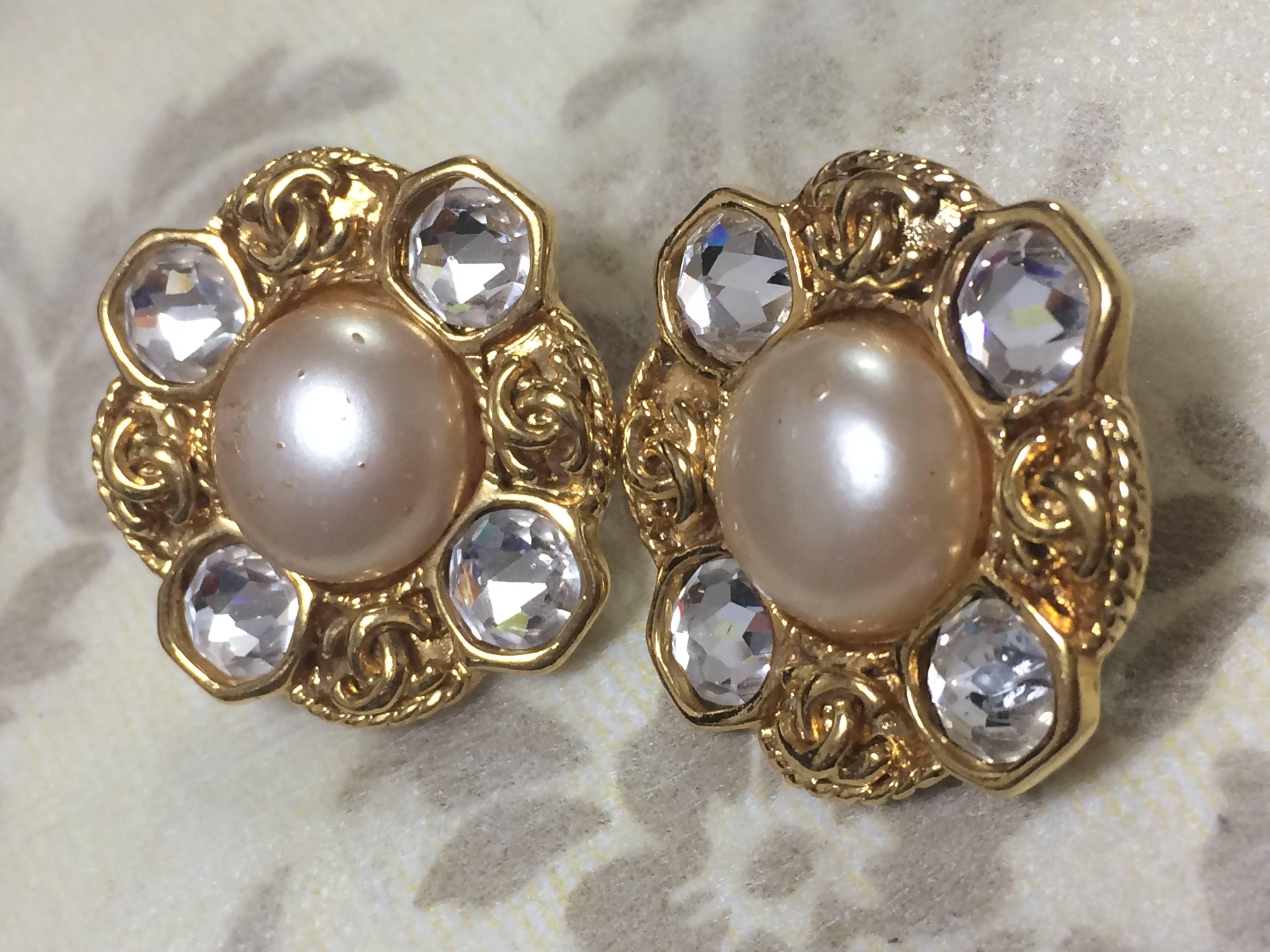 1990s. Vintage CHANEL gold tone earrings with a faux pearl, Swarovski crystal stones, and CC motifs. Great and rare Chanel vintage gift.

Fun and Chic and Gorgeous CHANEL earrings for  you or your loved one!  
Great gift idea. 

Introducing a