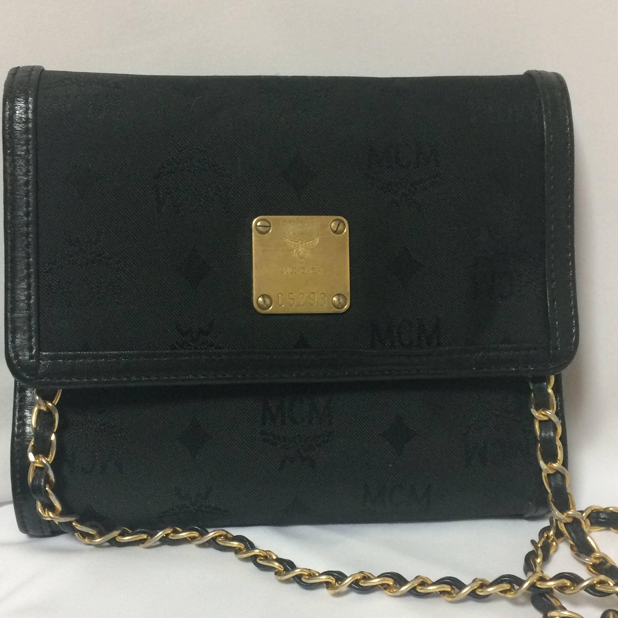 1990s. Vintage MCM black nylon monogram rare clutch shoulder bag with leather trimmings golden chain strap. Phenomenon, Big Bang.

MCM has been back in the fashion trend again!!
Now it's considered to be one of the must-have designer in