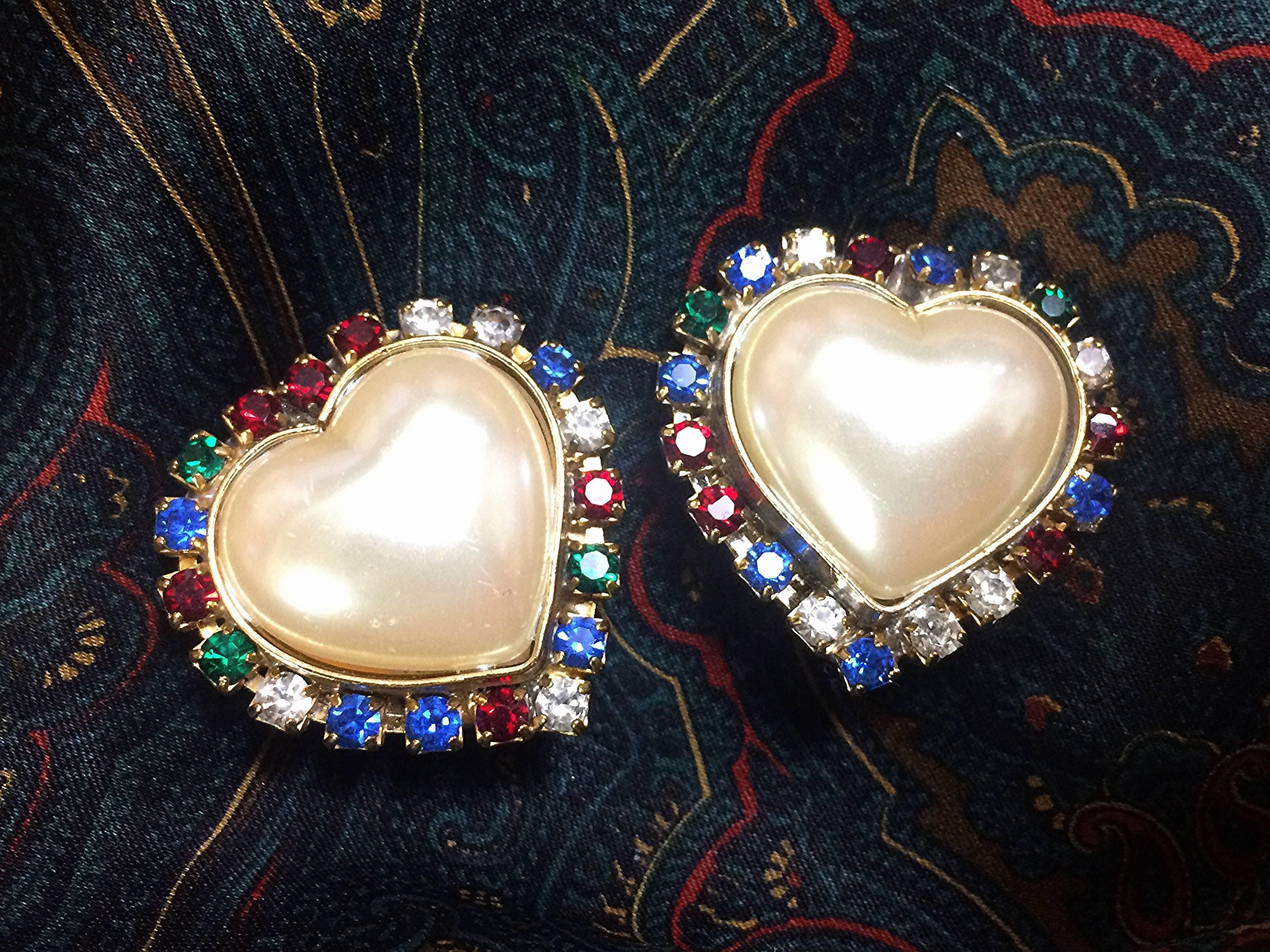 1990s. Vintage ESCADA faux pearl heart design earrings with red, clear, blue, and green crystals. Perfect vintage jewelry gift.

Fabulous heart shape faux pearl earrings with muticolor crystals around them from ESCADA back in the 90's.
Featuring