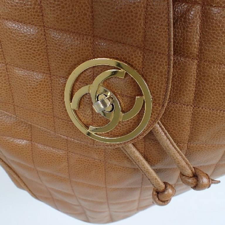 Brown Vintage CHANEL quilted brown caviar leather backpack with gold chain straps.