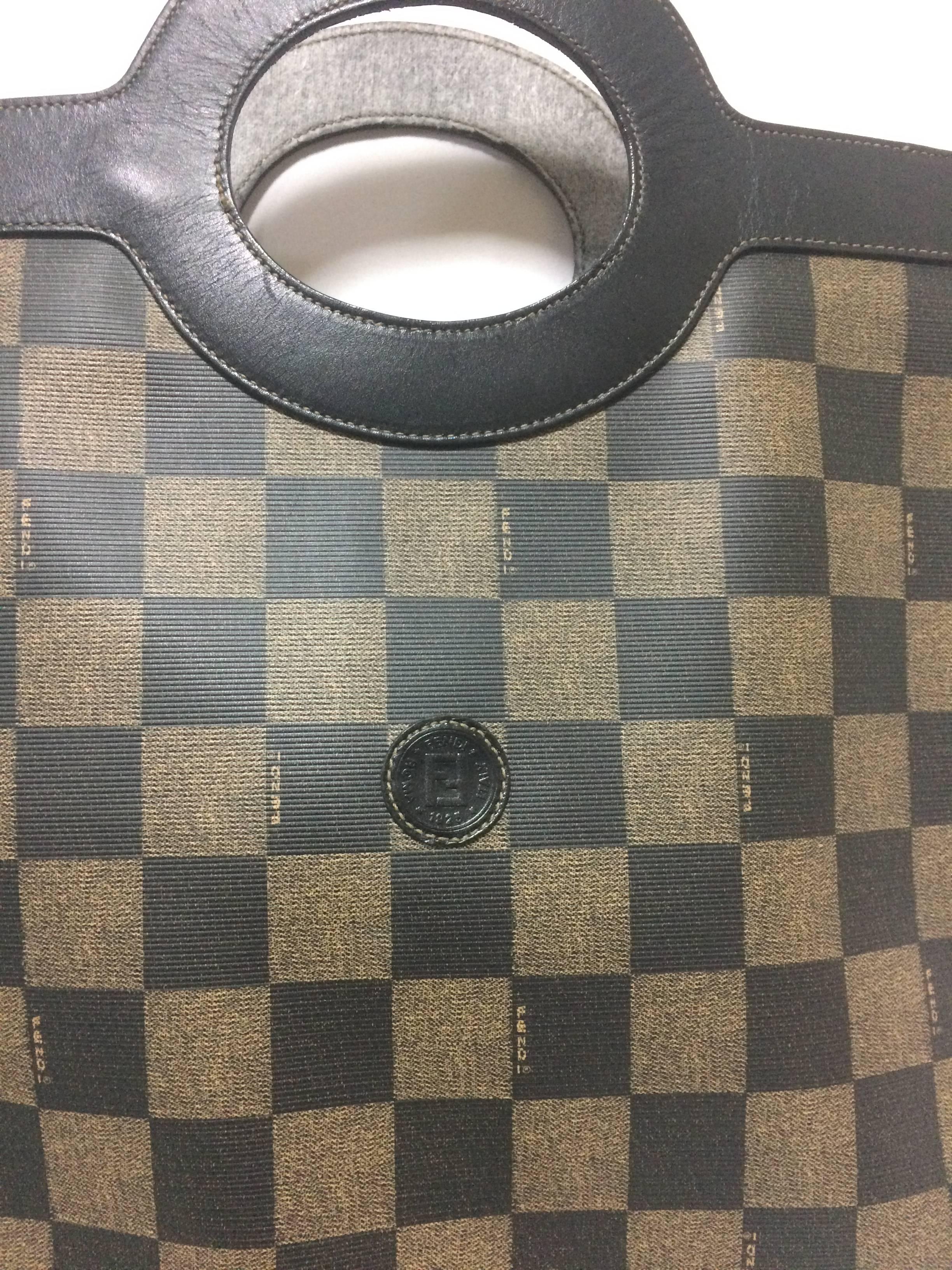 1990s. Vintage FENDI classic pecan chess pattern shopper tote bag with black leather trimming. Daily use handbag for Unisex.

For all Fendi vintage lovers, this purse is the one for you!

Very chic and cute shopper tote from FENDI back in the