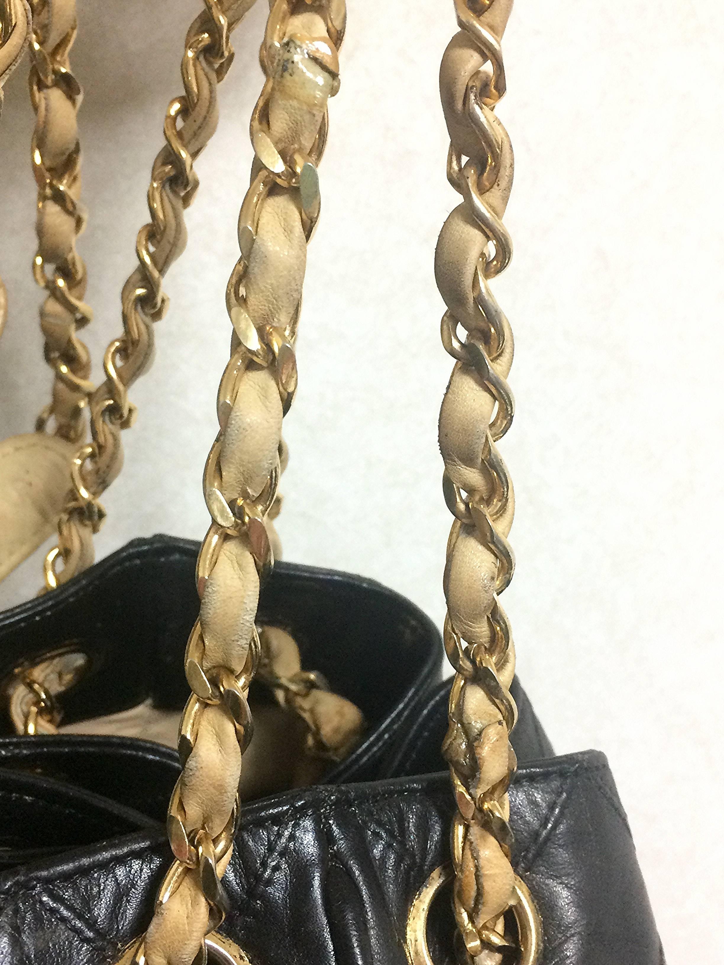 Women's Vintage CHANEL black and beige calf leather hobo bucket shoulder bag with charm.