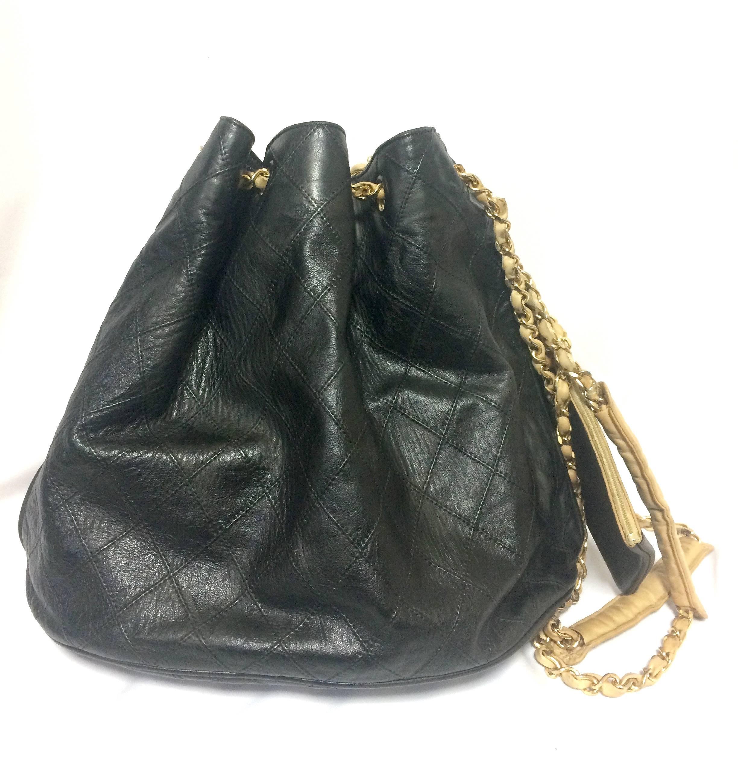 Black Vintage CHANEL black and beige calf leather hobo bucket shoulder bag with charm.