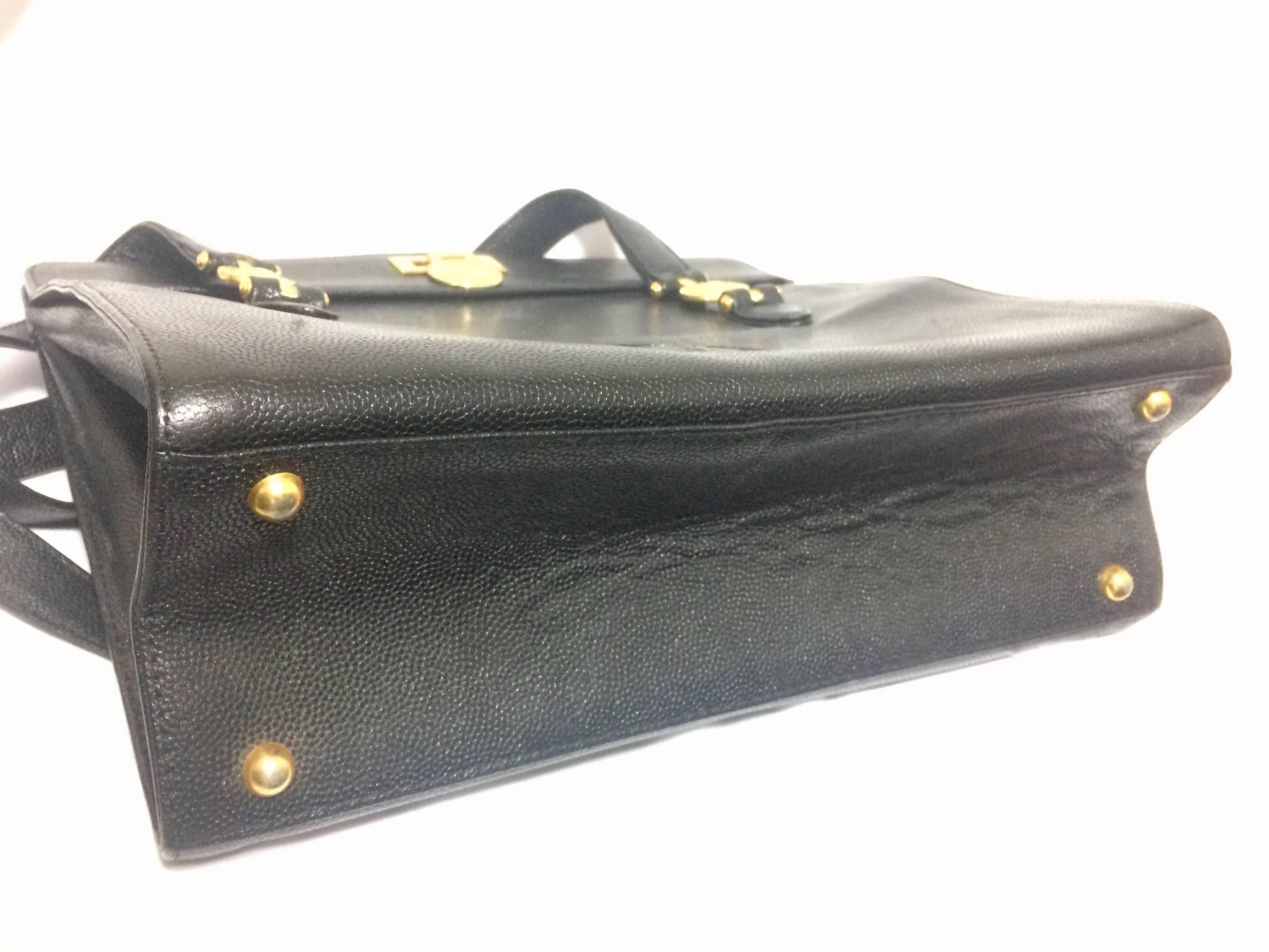 Women's or Men's Vintage Gianni Versace black leather tote bag with golden sunburst motifs. For Sale