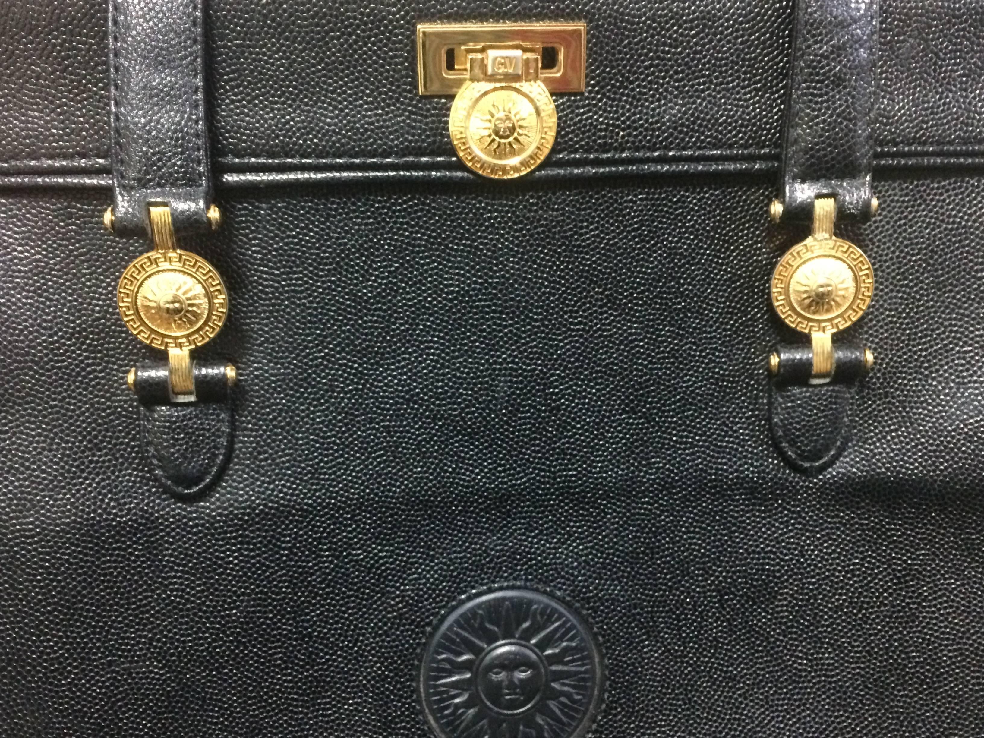 Black Vintage Gianni Versace black leather tote bag with golden sunburst motifs. For Sale