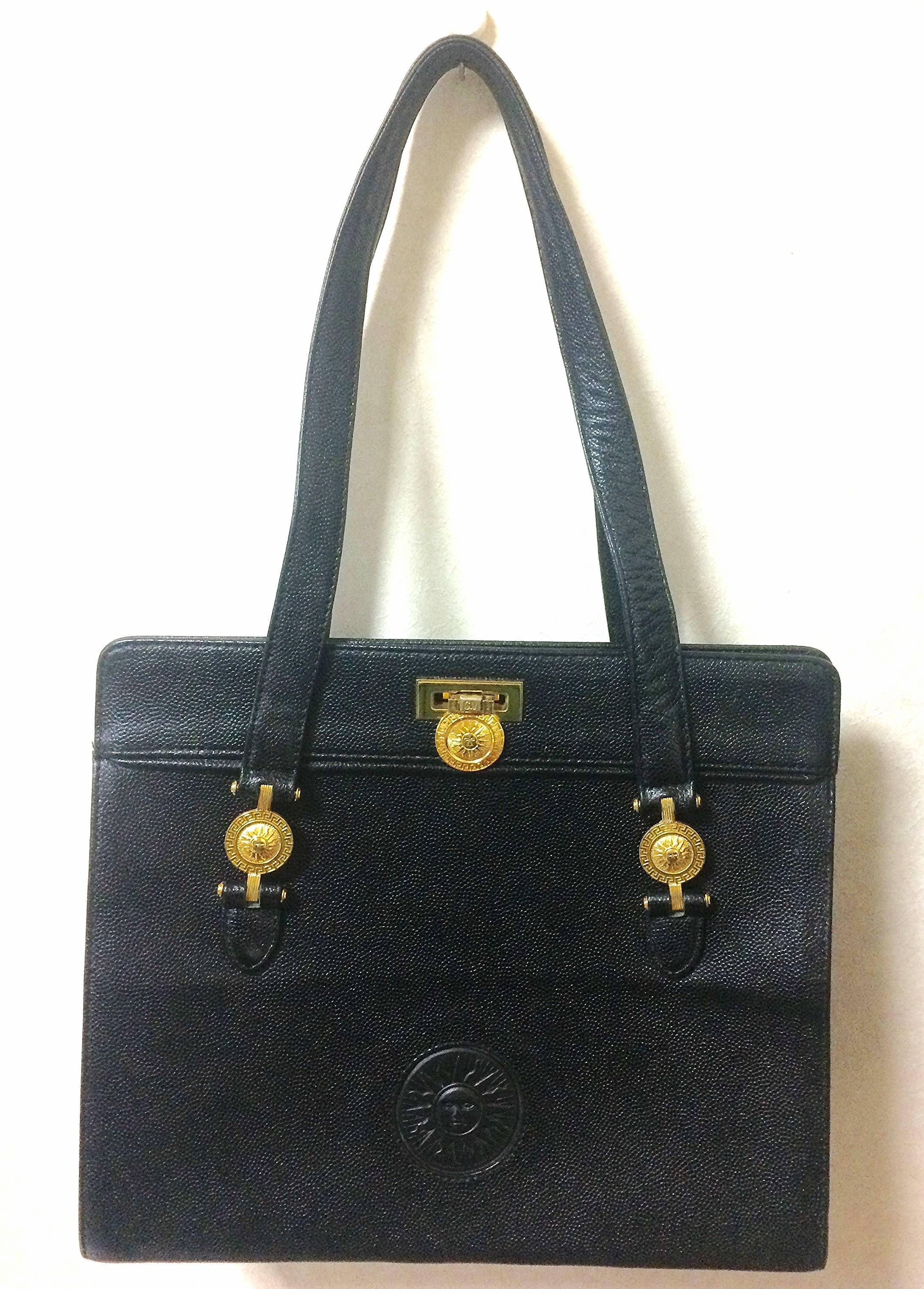 1990s. Vintage Gianni Versace black leather tote bag with golden sunburst motifs. Lady Gaga style shoulder bag for daily use.

Introducing another rare vintage masterpiece from Gianni Versace back in the 90's.
If you are looking for vintage