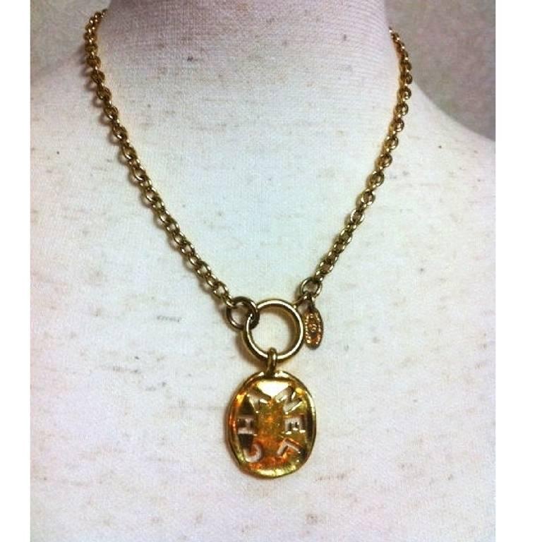 1990s. Vintage CHANEL golden chain necklace with cutout logo coin charm. Chanel coin charm is the accent and make you give the CHANEL look.

Fun, chic and Gorgeous!  Great gift idea. Free gift wrapping. 
Vintage Chanel gold tone chain necklace with