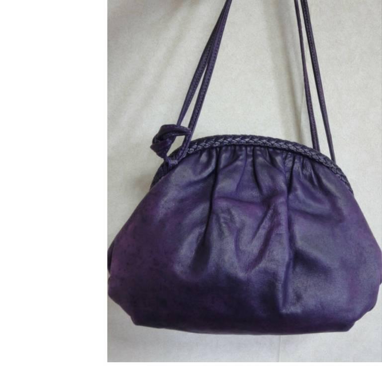 1980s. Vintage BALLY deep purple, violet genuine leather pouch, clutch style shoulder bag with golden B charm and braided kiss lock closure.

This is a vintage Bally genuine calfskin shoulder bag in pouch/clutch style.
Featuring its iconic gold tone